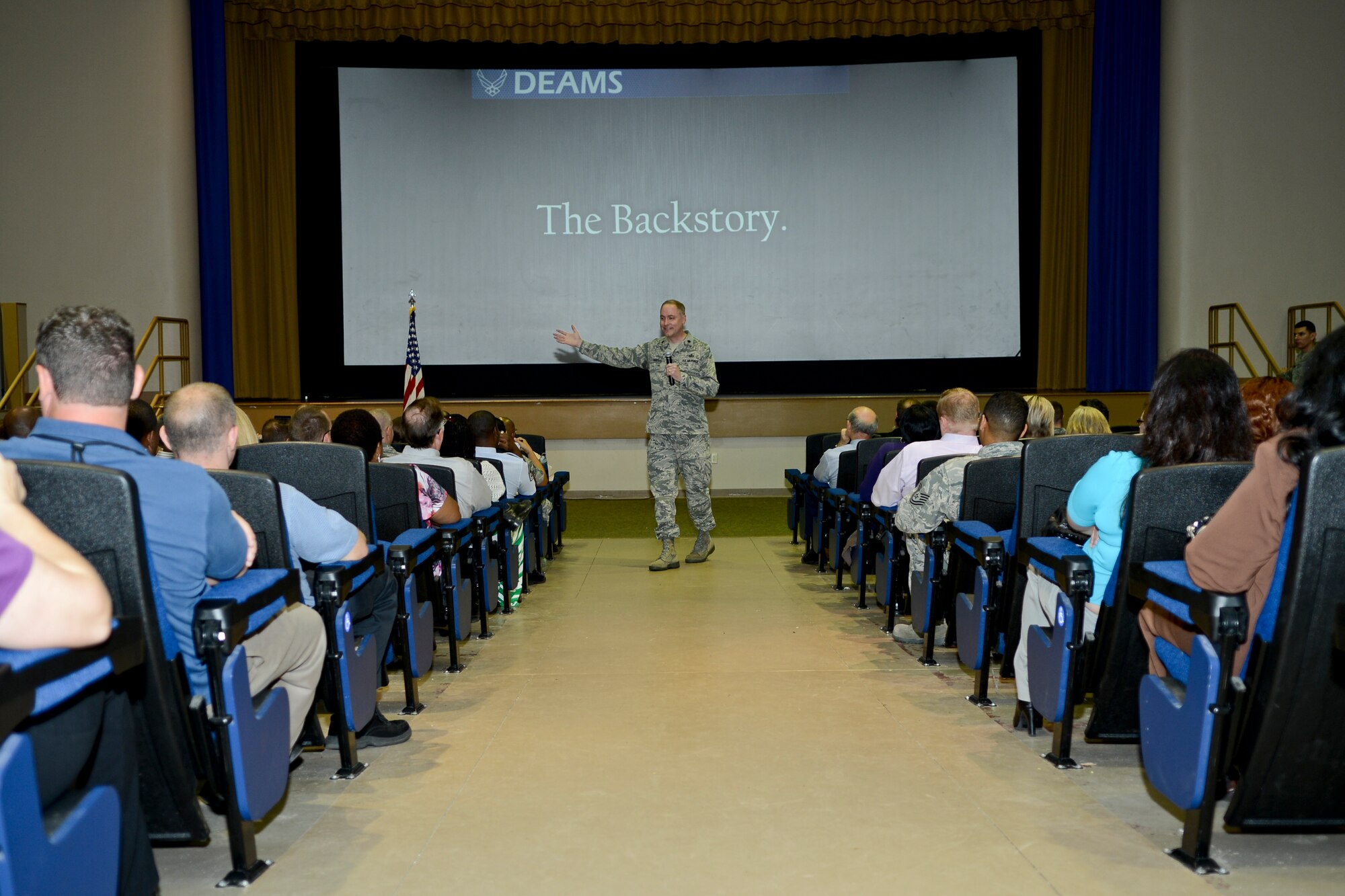 Lt. Col. Troy Sanders, Air Mobility Command Defense Enterprise Accounting and Management System implementation lead, speaks about the DEAMS during a town hall meeting May 1, 2014, at MacDill Air Force Base, Fla. DEAMS is a financial management initiative designed to transform business and financial management processes and systems. (U.S. Air Force photo by Senior Airman Melanie Bulow-Gonterman/Released)
