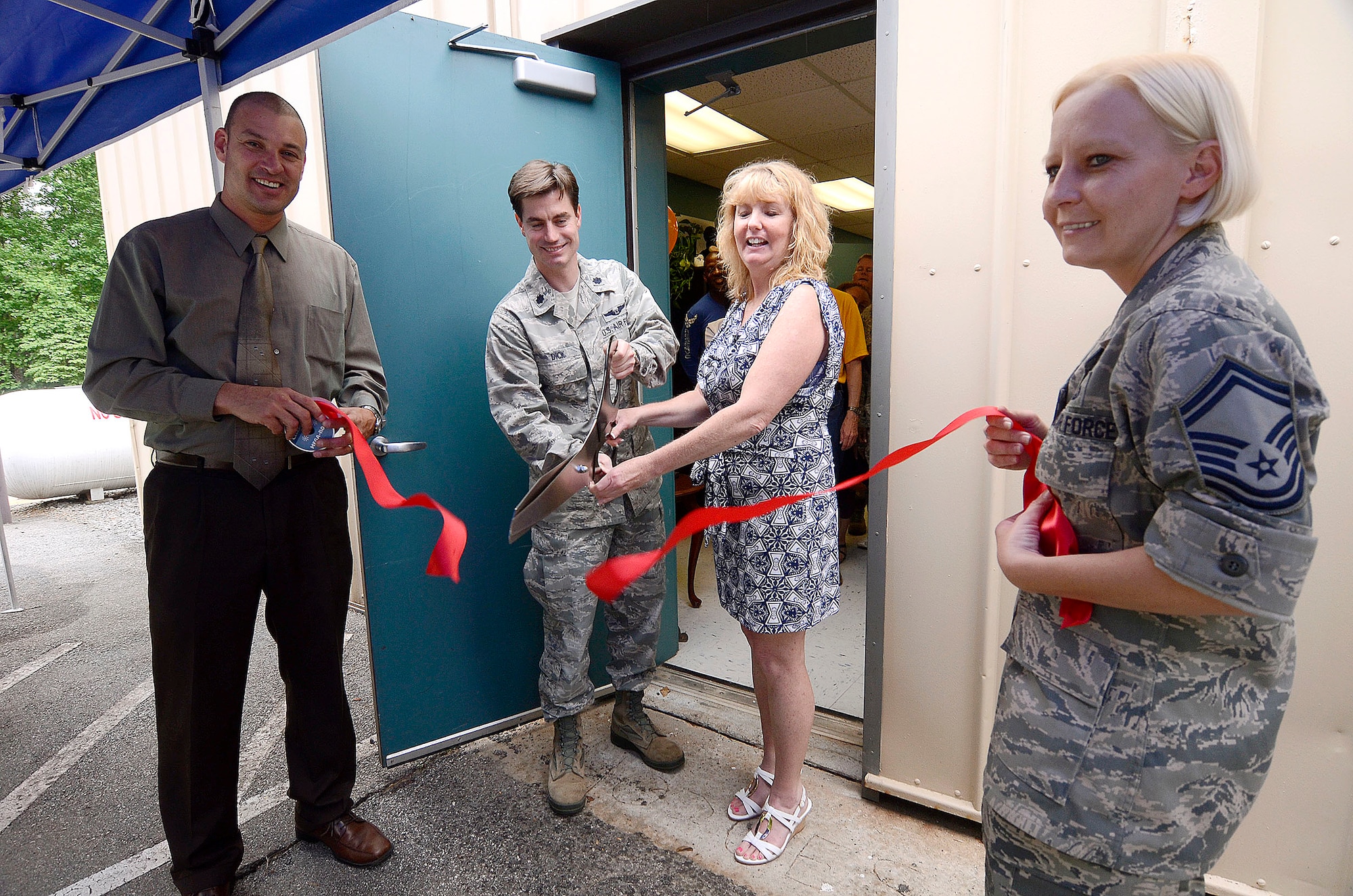 Timothy M. Case, Chief of Services, Lt. Col. David K. Dick, 94th Force Support Squadron commander, Susan E. Short, ITT manager, and Senior Master Sgt. Cinthia M. Webb, 94th Force Support Squadron performs a ribbon cutting ceremony marking the opening of the new location of the Information, Tickets and Travel office on Dobbins Air Reserve Base, Ga. May 9. The new larger office is collocated with recreation services creating a one-stop shopping experience for customers. (U.S. Air Force photo/Don Peek)