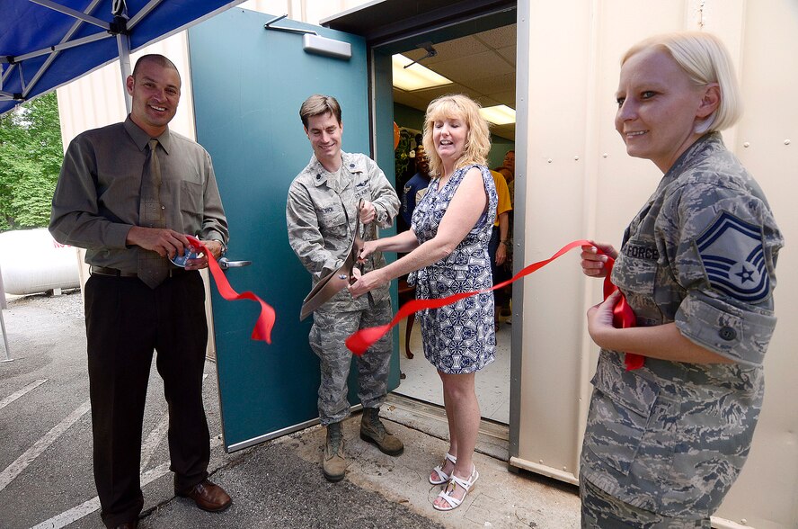 Timothy M. Case, Chief of Services, Lt. Col. David K. Dick, 94th Force Support Squadron commander, Susan E. Short, ITT manager, and Senior Master Sgt. Cinthia M. Webb, 94th Force Support Squadron performs a ribbon cutting ceremony marking the opening of the new location of the Information, Tickets and Travel office on Dobbins Air Reserve Base, Ga. May 9. The new larger office is collocated with recreation services creating a one-stop shopping experience for customers. (U.S. Air Force photo/Don Peek)