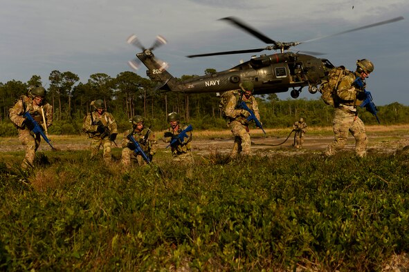 U.S. Air Force combat controllers conduct fast-rope insertion training using a U.S. Navy HH-60H Seahawk helicopter assigned to Helicopter Sea Combat Squadron (HSC) 84 at Hurlburt Field, Fla., May 2, 2014, during Emerald Warrior 2014. Emerald Warrior is a U.S. Special Operations Command-sponsored two-week joint/combined tactical exercise designed to provide realistic military training in an urban setting. (U.S. Air Force photo by Staff Sgt. Tim Chacon)