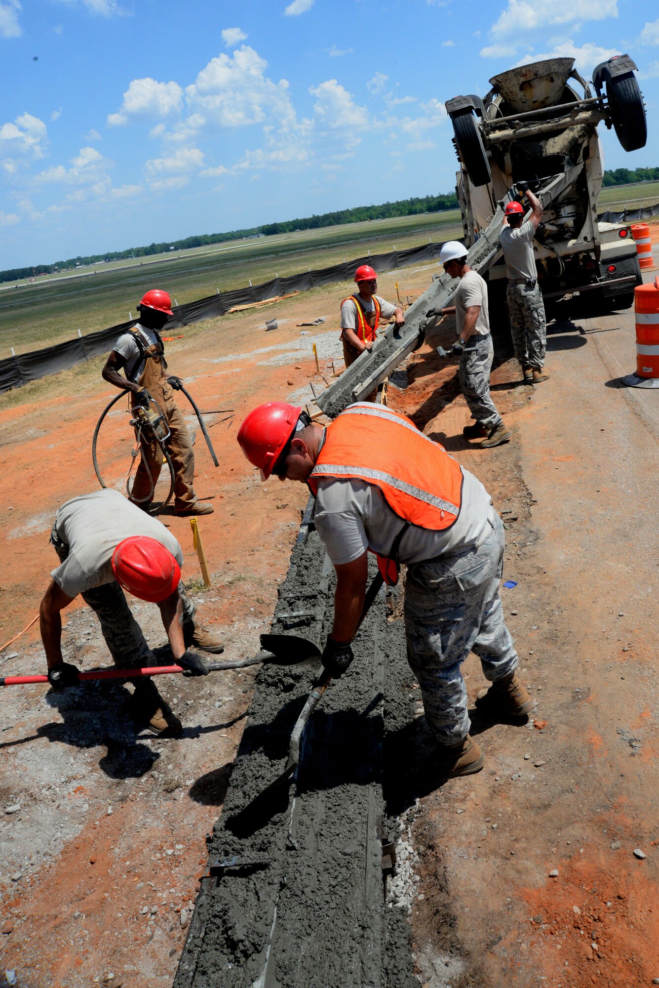 U.S. Air Force Civil Engineer Airmen with the 823rd Rapid Engineer Deployable Heavy Operational Repair Squadron Engineers assigned to Hurlburt Field, Fla., mold and smooth concrete to make a new section of curbing along Patrol Road at Shaw Air Force Base, S.C., May 8, 2014. The 46 Airmen have three construction projects to complete while at Shaw AFB. (U.S. Air Force photo by Airman 1st Class Michael A. Cossaboom/Released)