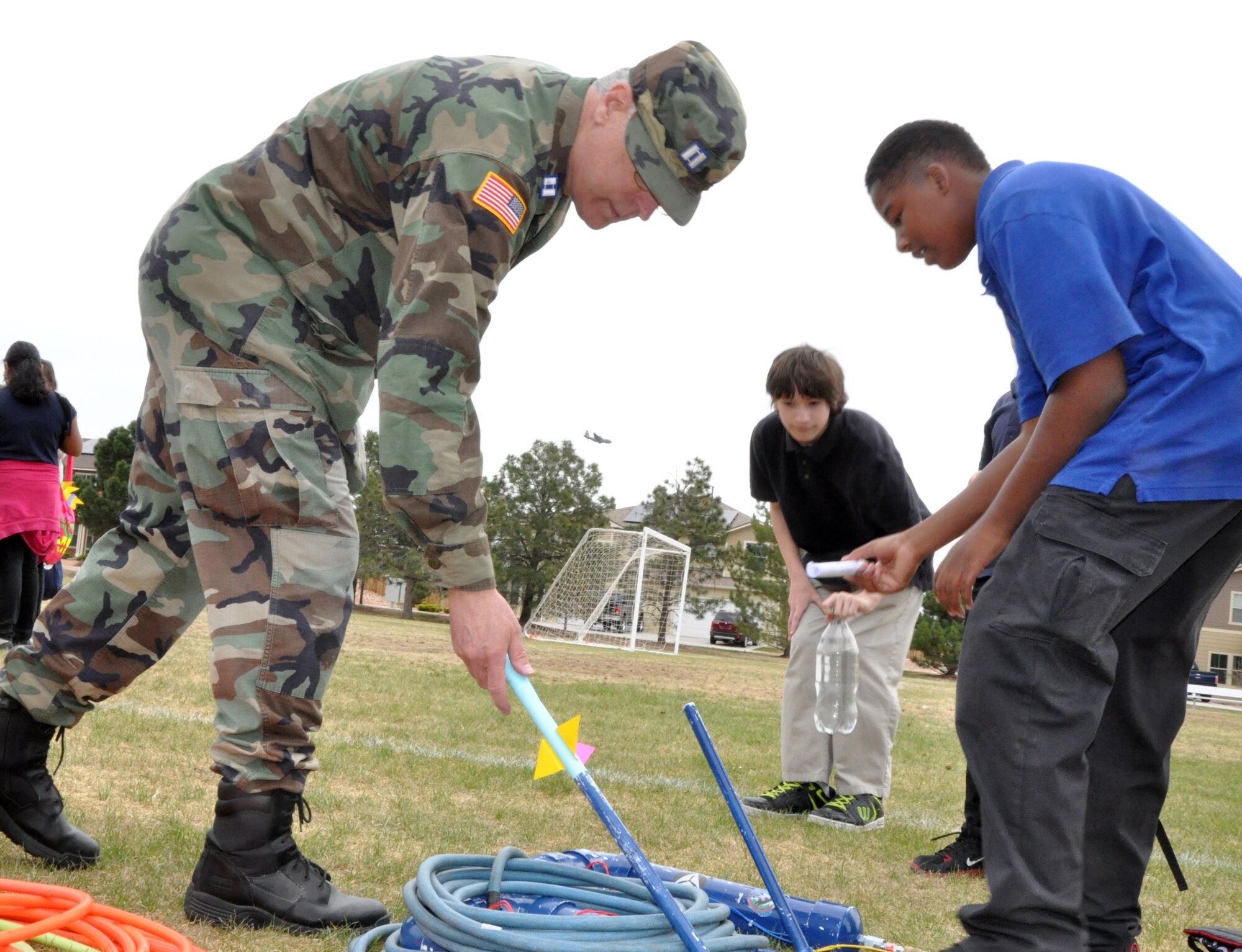 PETERSON AIR FORCE BASE, Colo. – Capt. Bill Blatchley, Colorado Springs Cadet Squadron aerospace education officer, prepares a model rocket for testing by a local student. The Civil Air Patrol brought along a rocket launcher to the field day for Jack Swigert Aerospace Academy students held at Patriot Park May 6. The field day allowed the school children to make and test rockets with the help of on-site experts as a part of their curriculum. The students also visited the Peterson Air and Space Museum to tour real aircraft and rockets. (U.S. Air Force photo/Alethea Smock)