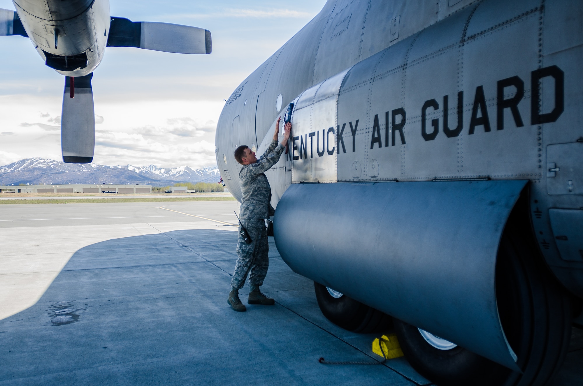 Master Sgt. Lonie Gipson, an expediter for the 123rd Aircraft Maintenance Squadron, installs an auxiliary power unit cover on a Kentucky Air National Guard C-130 Hercules prior to flight operations at Joint Base Elmendorf-Richardson, Alaska, on May 8, 2014. More than 100 Airmen from the Kentucky Air National Guard’s 123rd Airlift Wing are currently deployed to participate in Red Flag-Alaska. (U.S. Air National Guard photo by Master Sgt. Phil Speck)