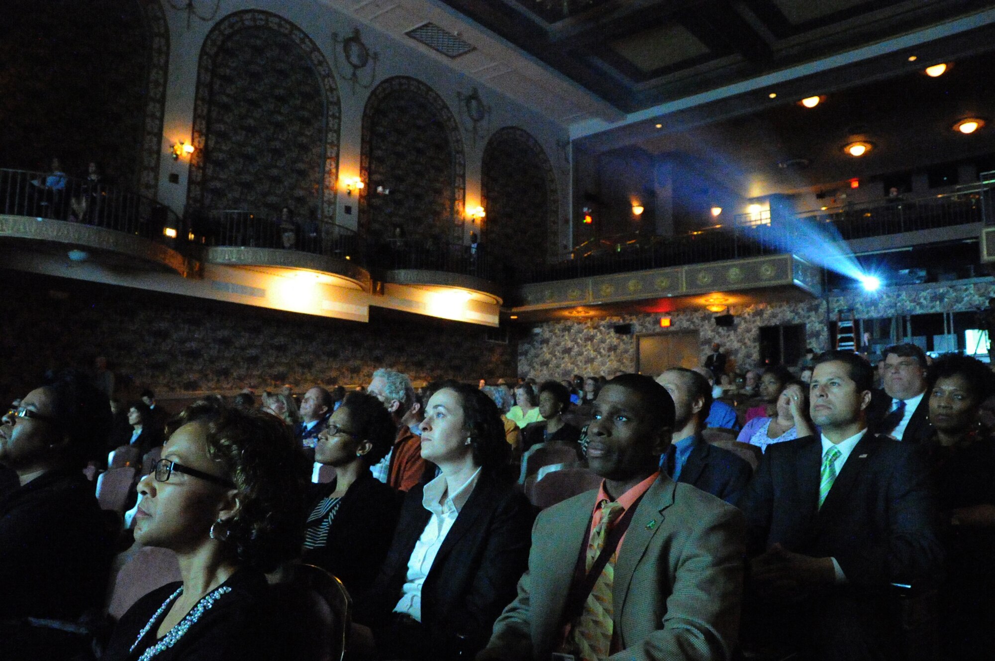 Members of the audience watch a video of a survivor's experience during the Federal Inter-Agency Holocaust Remembrance Program "Eyewitness To Evil" at the Lincoln Theater in Washington D.C., May 7, 2014. The program invited Air Force District of Washington Commander Maj. Gen. Sharon K. G. Dunbar as a keynote speaker as well as survivors of the Holocaust and Bosnian War to share their stories. (U.S. Air Force photo/Staff Sgt. Matt Davis)