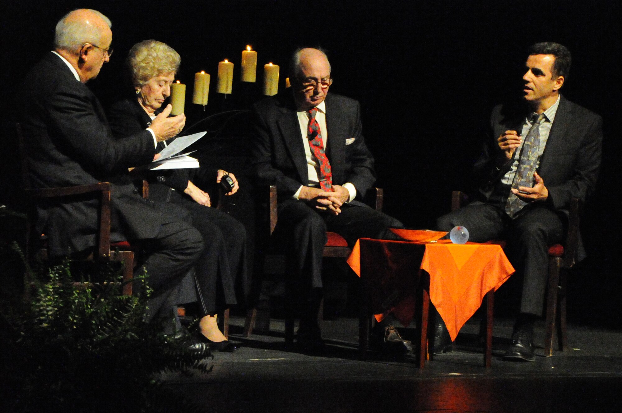 ABC7 Anchor Gordon Peterson listens to a story from survivor Sead Okic during the Federal Inter-Agency Holocaust Remembrance Program "Eyewitness To Evil" at the Lincoln Theater in Washington D.C., May 7, 2014. The program invited Air Force District of Washington Commander Maj. Gen. Sharon K. G. Dunbar as a keynote speaker as well as survivors of the Holocaust and Bosnian War to share their stories. (U.S. Air Force photo/Staff Sgt. Matt Davis)