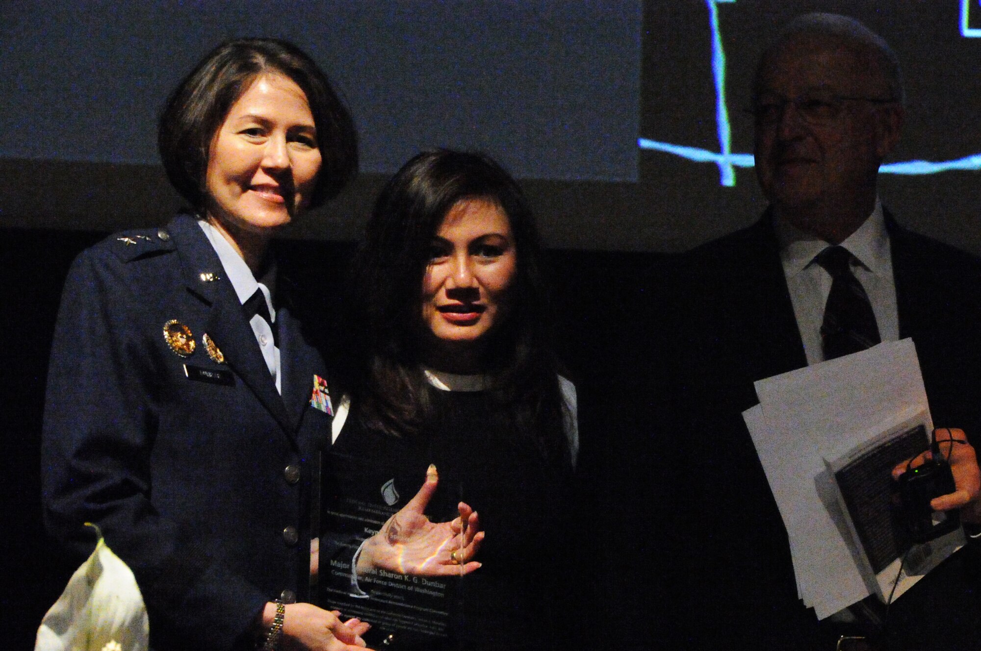 Air Force District of Washington Commander Maj. Gen. Sharon K. G. Dunbar is presented a plaque for speaking during the Federal Inter-Agency Holocaust Remembrance Program "Eyewitness To Evil" at the Lincoln Theater in Washington D.C., May 7, 2014. The program invited Maj. Gen. Dunbar as a keynote speaker as well as survivors of the Holocaust and Bosnian War to share their stories. (U.S. Air Force photo/Staff Sgt. Matt Davis)