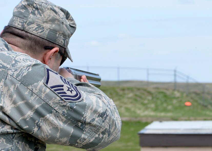 Master Sgt. Charles Stepp, 28th Communications Squadron operations flight chief, takes aim at a clay target during a competition at the trap and skeet range at Ellsworth Air Force Base, S.D., May 2, 2014. Trap and skeet shooting is a recreational and competitive activity where participants use shotguns to fire at clay disks launched from special throwers. (U.S. Air Force photo by Senior Airman Anania Tekurio/Released) 