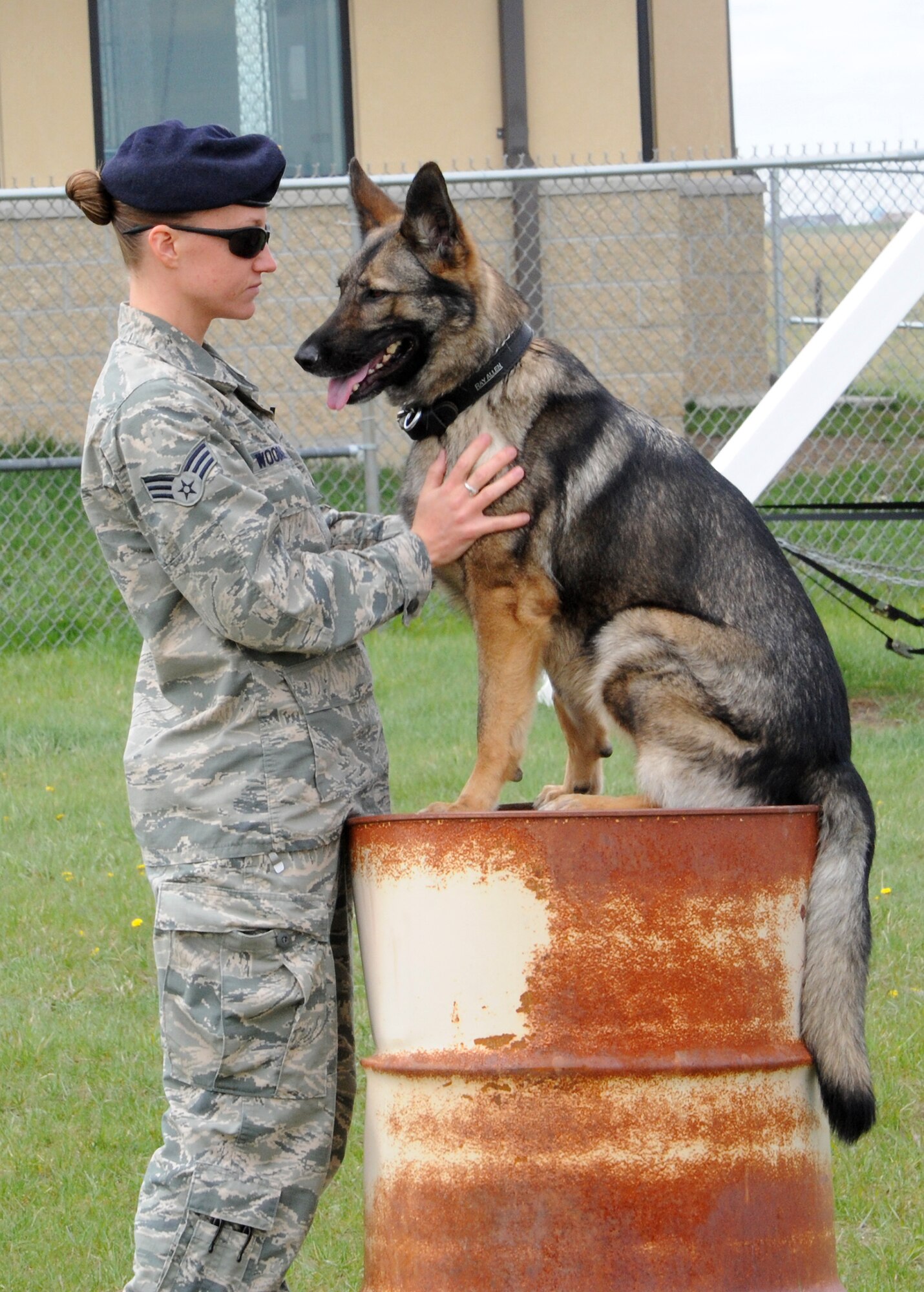 Gina and her handler, Senior Airman Jessica Woodall, both members of the 341st Security Forces Squadron military working dog section, do some bonding before getting back to work. (U.S. Air Force photo/Senior Airman Cortney Paxton)