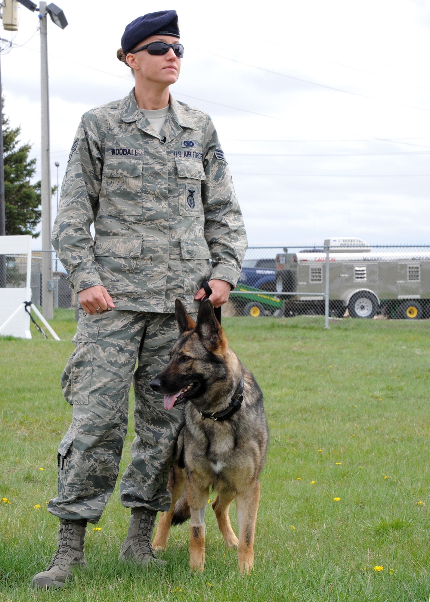 Gina and her handler, Senior Airman Jessica Woodall, both members of the 341st Security Forces Squadron military working dog section, pose for a photo at the kennels May 7.  Building a strong bond with their handler is part of all MWD’s careers. (U.S. Air Force photo/Senior Airman Cortney Paxton)