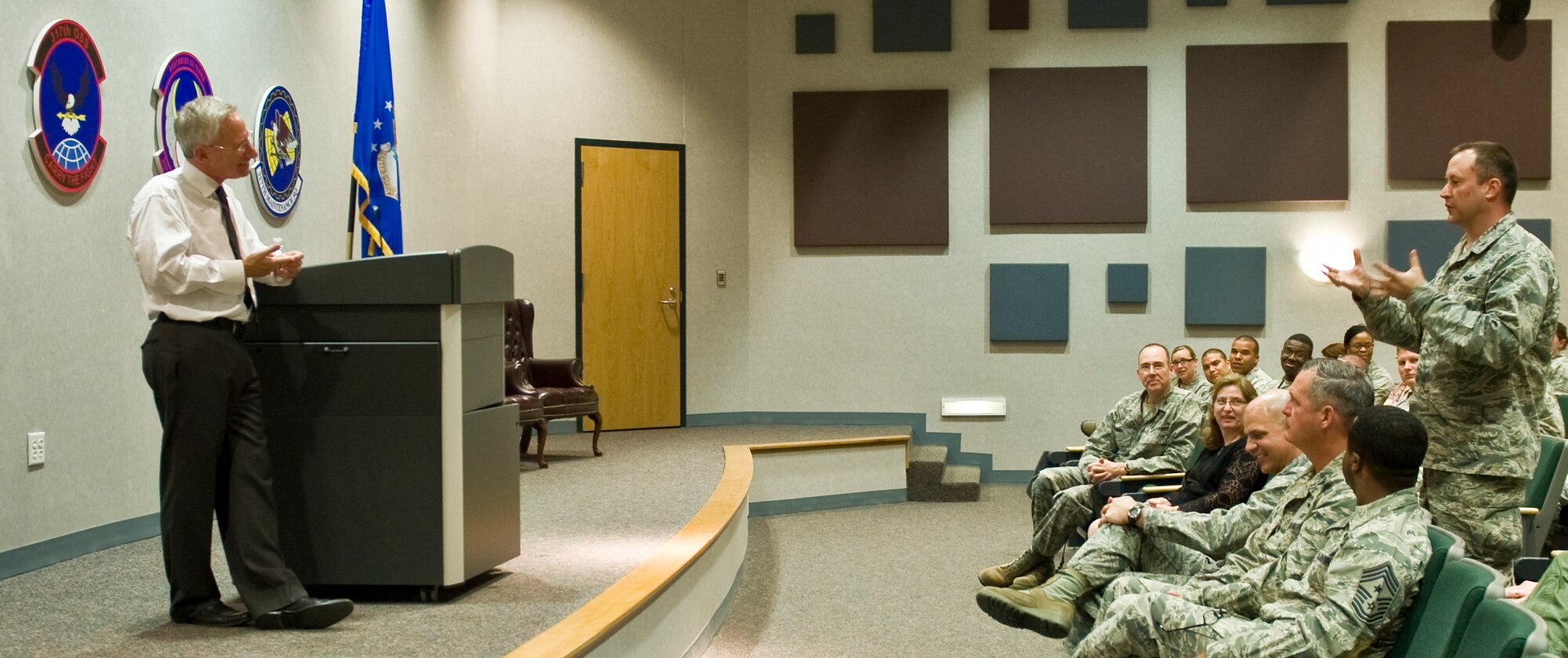 U.S. Air Force Col. Brian Yates, right, asks Dr. David Itkin, Abilene Philharmonic Orchestra conductor, a question regarding leadership May 5, 2014, at Dyess Air Force Base, Texas. Itkin is able to relate to Air Force leaders, because an orchestra has a similar hierarchy structure to the military. During a speech, Itkin explained that when leaders lead by example, they have the right to demand just about anything of their subordinates; when leaders don’t lead by example, they don’t have the right to demand anything. Itkin stated that when leaders lead by example, they’re able to inspire subordinates to use their skills, which raises the productivity and quality of the entire organization. A leader’s job, in his opinion, can be boiled down to three words: make things better. (U.S. Air Force photo by Airman 1st Class Autumn Velez/Released)