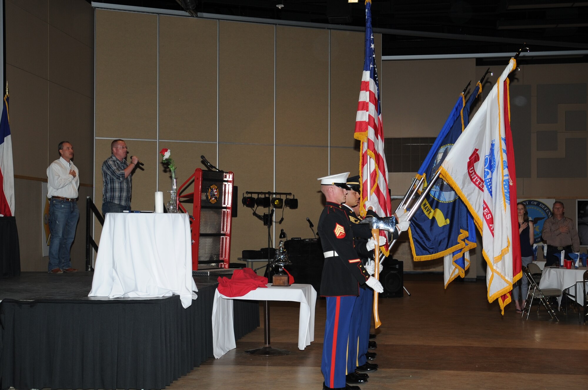SAN ANGELO, Texas -- Marine Corps Staff Sgt. Dewayne D. Meats Jr., Marine Corps Detachment and Louis F. Garland DOD Fire Academy Crash Fire Rescue instructor, performs the national anthem as the Department of Defense Fire Academy Joint Service Color Guard present the colors during the Military Firefighter Heritage Foundation’s Annual Firefighter Muster at the McNease Convention Center here May 3. The muster was a dinner and award ceremony. (U.S. Air Force photo/ Staff Sgt. Laura R. McFarlane)