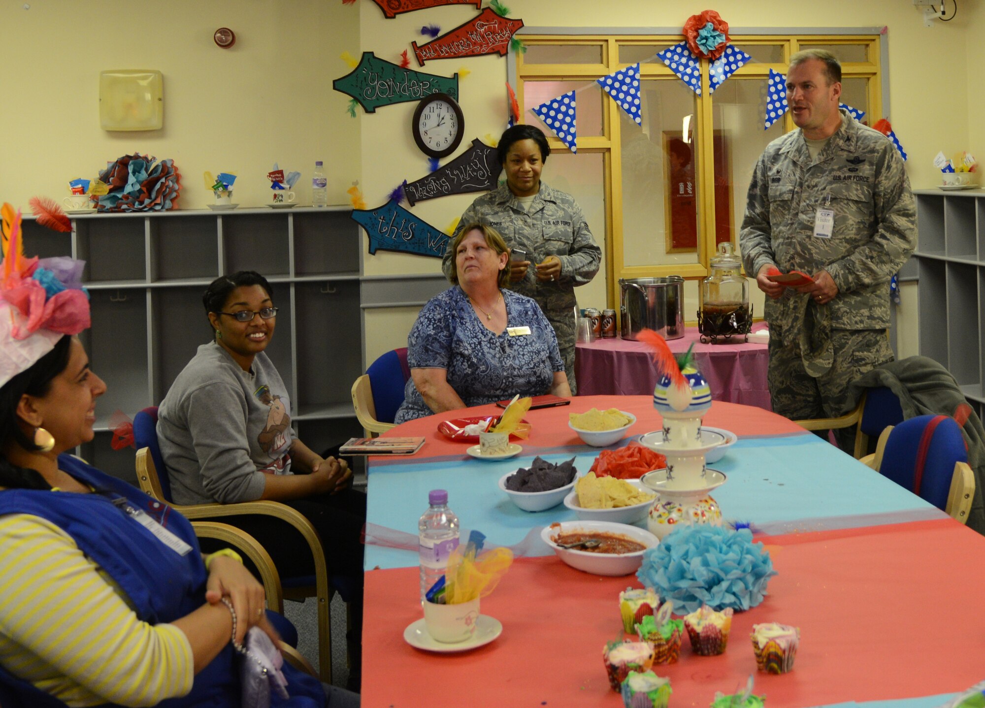 U.S. Air Force Col. Kenneth T. Bibb Jr., right, 100th Air Refueling Wing commander, speaks to RAF Mildenhall Child Development Center staff during the “Mad Hatter Tea Party” at the CDC May 8, 2014, on RAF Mildenhall, England. The Parent Advisory Council hosted the tea party as a way to show their appreciation for everything the CDC does for RAF Mildenhall families. (U.S. Air Force photo by Airman 1st Class Kelsey Waters/Released)