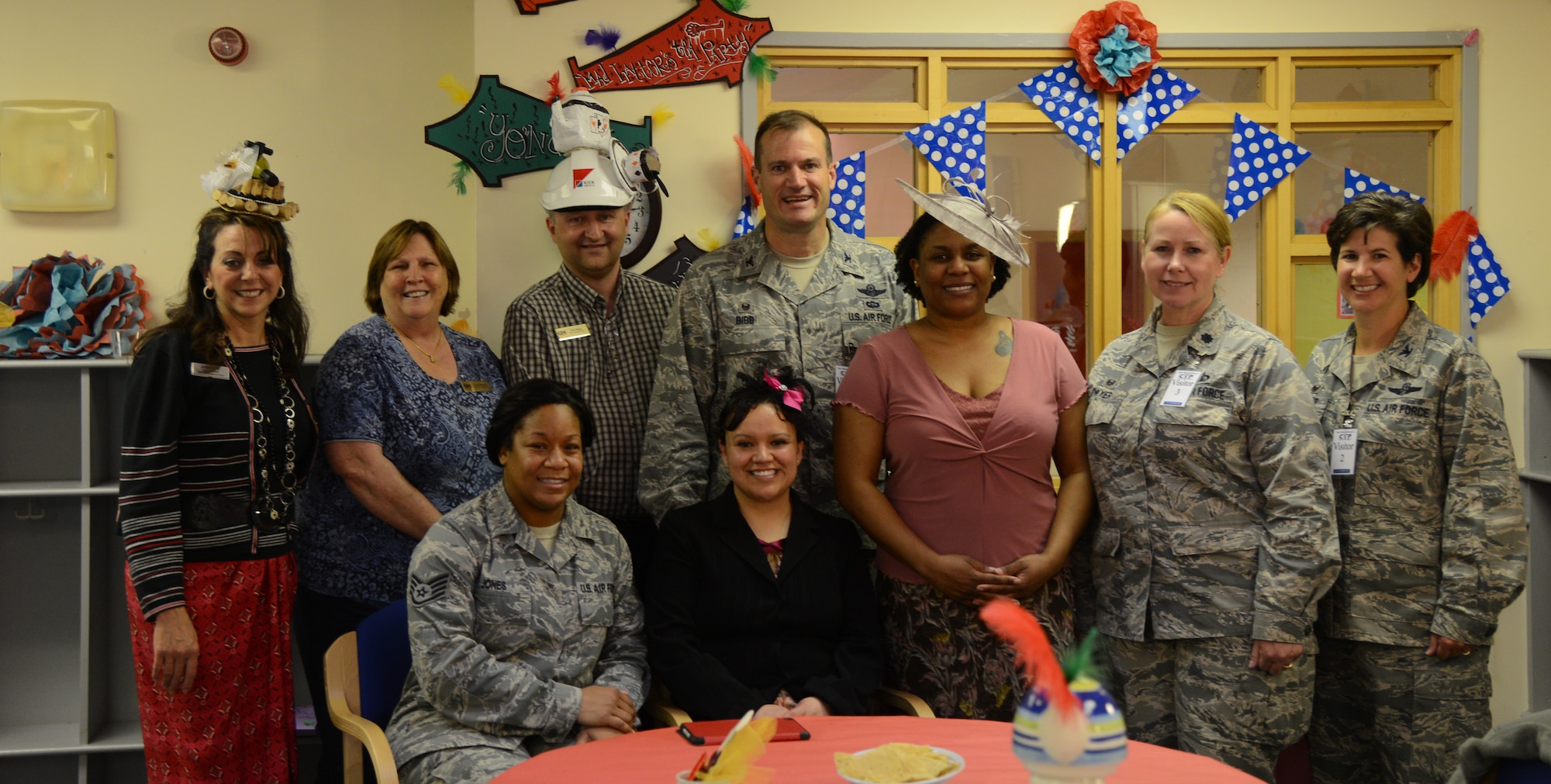 Team Mildenhall leadership, RAF Mildenhall Child Development Center and the Parent Advisory Council members, pose for a photo during the “Mad Hatter Tea Party” at the CDC May 8, 2014, on RAF Mildenhall, England. The tea party included a hat contest and snacks for the child care providers. (U.S. Air Force photo by Airman 1st Class Kelsey Waters/Released)