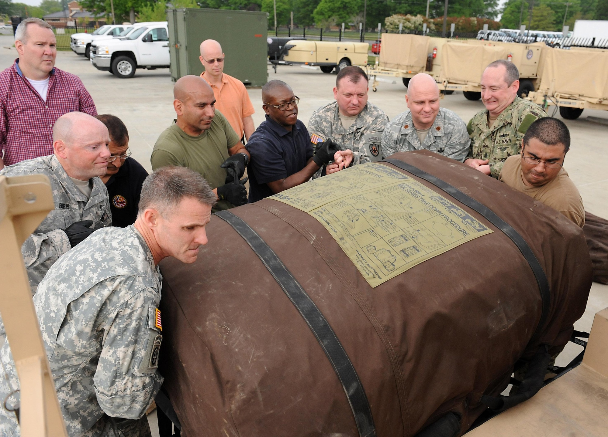 Members of Joint Task Force Civil Support set up Deployable Rapid Assembly Shelters during an Early Entry Command Post deployment exercise at Fort Eustis, Va., May 8, 2014. DRASH is a portable shelter that can be set up within minutes of arriving on-site with no special tools. JTF-CS is preparing for Sudden Response 2014 which will test the unit's movement of equipment and personnel during the initial phases of a simulated man-made or natural disaster. JTF-CS anticipates, plans and prepares for chemical, biological, radiological and nuclear defense support to civil authorities response operations. (Official DOD photo by U.S. Navy Petty Officer 1st Class Brian Dietrick)