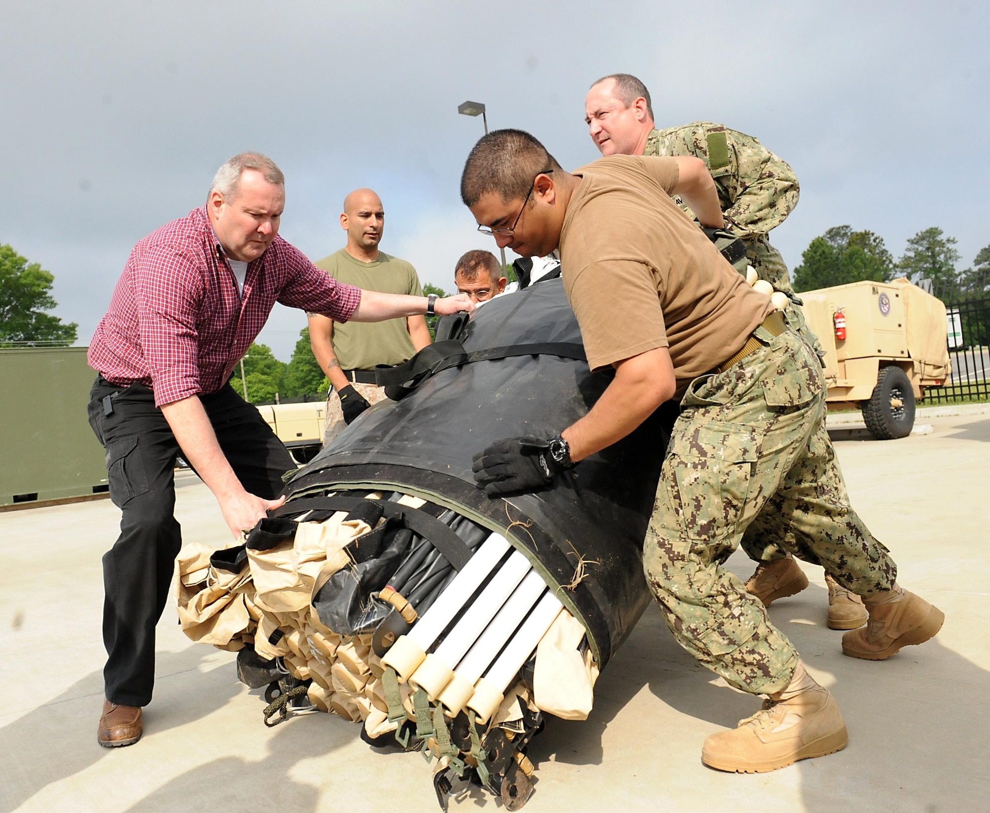 Members of Joint Task Force Civil Support set up Deployable Rapid Assembly Shelters during an Early Entry Command Post deployment exercise at Fort Eustis, Va., May 8, 2014. DRASH is a portable shelter that can be set up within minutes of arriving on-site with no special tools. JTF-CS is preparing for Sudden Response 2014 which will test the unit's movement of equipment and personnel during the initial phases of a simulated man-made or natural disaster. JTF-CS anticipates, plans and prepares for chemical, biological, radiological and nuclear defense support to civil authorities response operations. (Official DOD photo by U.S. Navy Petty Officer 1st Class Brian Dietrick)