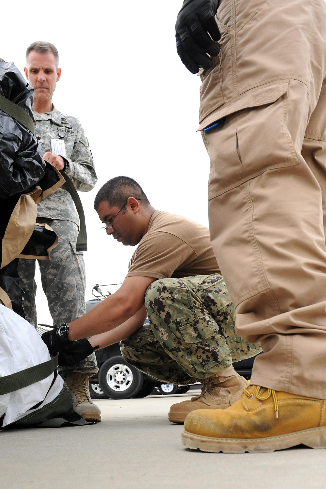 U.S. Navy Petty Officer 1st Class James Martinez, operations specialist, Joint Task Force Civil Support, assists with the setup of Deployable Rapid Assembly Shelters during an Early Entry Command Post deployment exercise at Fort Eustis, Va., May 8, 2014. DRASH is a portable shelter that can be set up within minutes of arriving on-site with no special tools. JTF-CS is preparing for Sudden Response 2014 which will test the unit's movement of equipment and personnel during the initial phases of a simulated man-made or natural disaster. JTF-CS anticipates, plans and prepares for chemical, biological, radiological and nuclear defense support to civil authorities response operations. (Official DOD photo by U.S. Navy Petty Officer 1st Class Brian Dietrick)