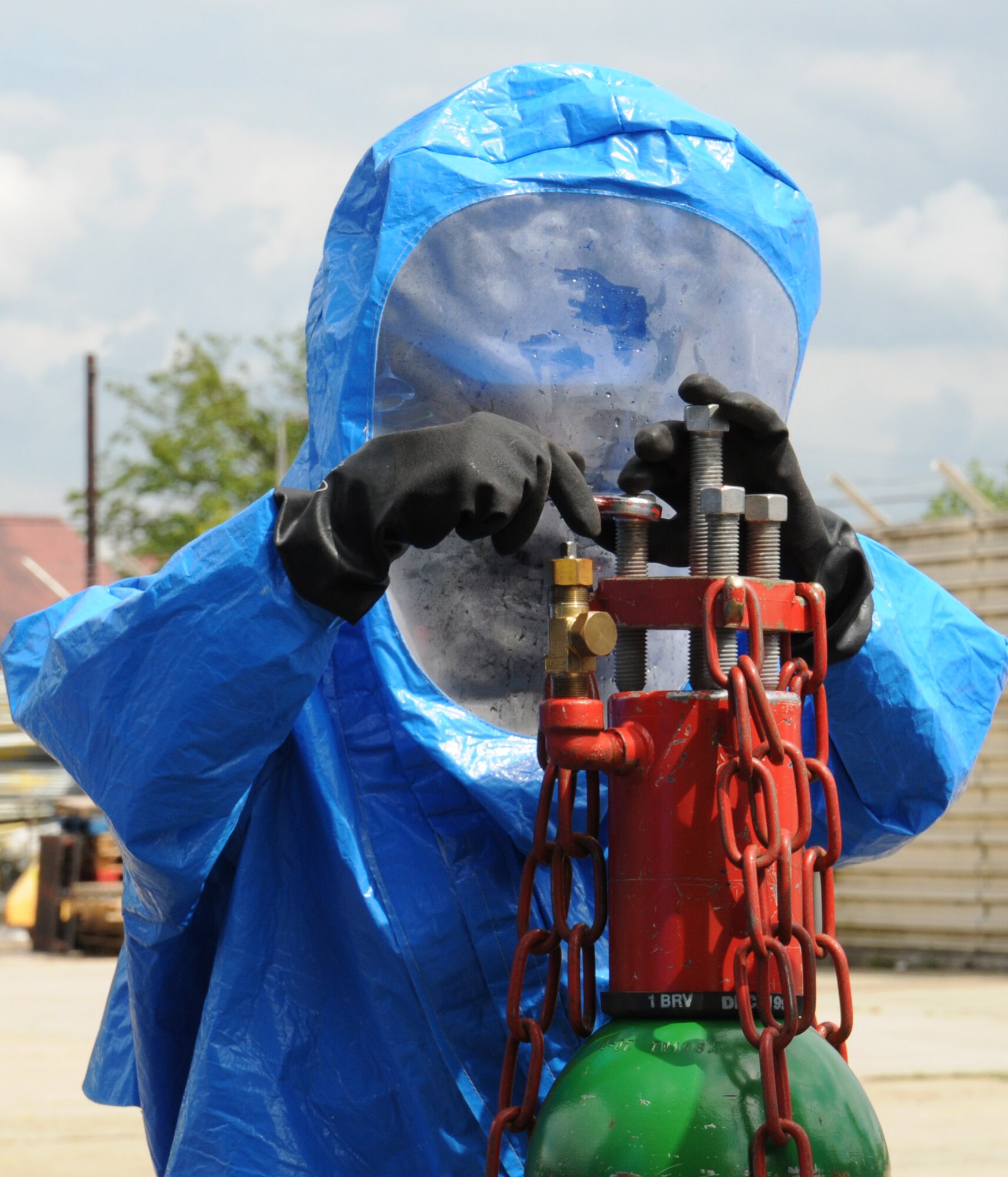 A 100th Civil Engineer Squadron Fire Department firefighter uses a chlorine “A” valve kit to stop a leak from a damaged cylinder valve during a hazardous materials exercise May 6, 2014, on RAF Mildenhall, England. The base exercises regularly to ensure emergency responders remain proficient on the use of equipment for any real-world incidents. (U.S. Air Force photo by Gina Randall/Released)