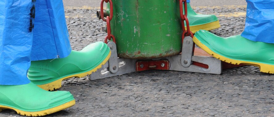 100th Civil Engineer Squadron Fire Department firefighters and emergency managers steady a chlorine “A” base from a Chlorine Institute Emergency Kit “A” during a hazardous materials exercise May 6, 2014, on RAF Mildenhall, England. The base exercises regularly to ensure emergency responders remain proficient for any real-world incidents.  (U.S. Air Force photo by Gina Randall/Released)
