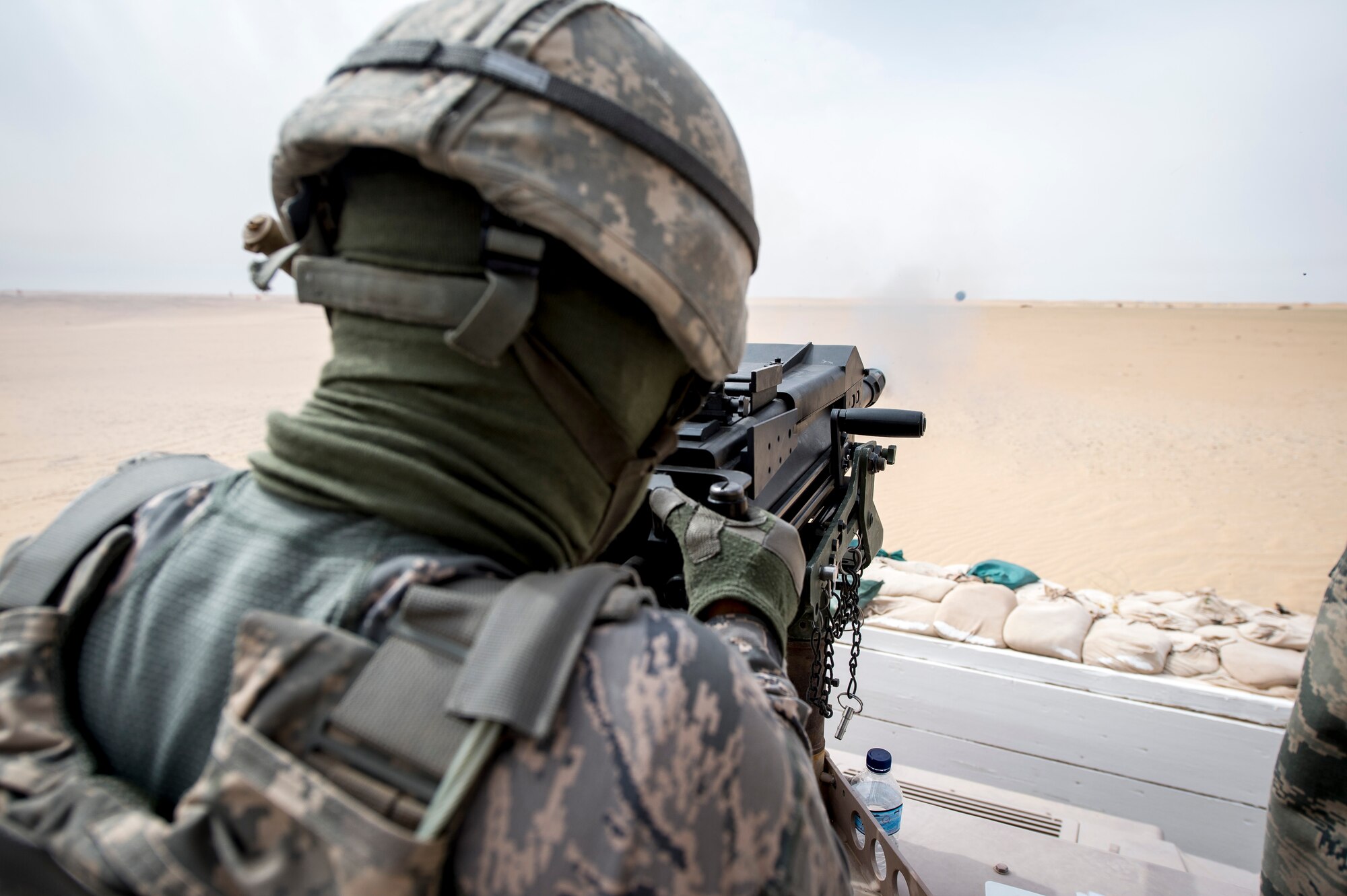 U.S. Air Force Senior Airman Ethan Grinder, 386th Expeditionary Security Forces Squadron, fires a Mark 19 40mm grenade machine gun on May 7, 2014 at an undisclosed location in Southwest Asia. Grinder is deployed from the 99th Security Forces Squadron at Nellis Air Force Base, Nev. Qualified Security Forces members practice shooting about every two months to maintain proficiency with the weapons system. (U.S. Air Force photo by Staff Sgt. Jeremy Bowcock)