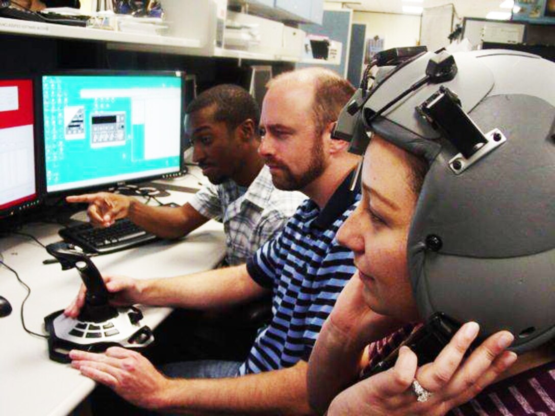 579th Software Maintenance Squadron Flight C employees Rickey King (left), Ray Vines (center) and Suzy Crespo, perform testing of ALQ-213 3-D audio organic software. (U.S. Air Force photo by Ed Aspera)