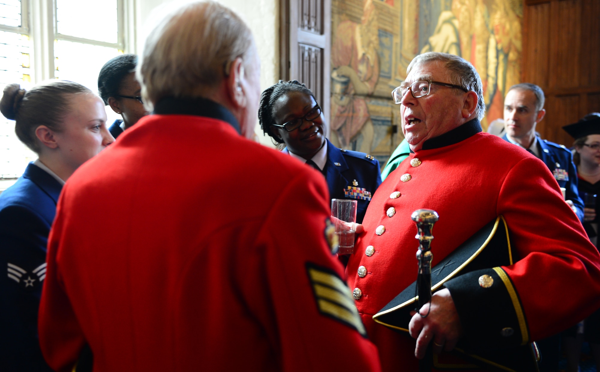 Airmen from the 48th Medical Group, dressed in blue, speak with Chelsea Pensioners, retired members of the British Army, before a ceremony at Westminster Abbey, England, May 7, 2014. The Florence Nightingale Foundation is a living memorial and hosts an annual remembrance service. (U.S. Air Force photo by Airman 1st Class Dawn M. Weber/Released)
