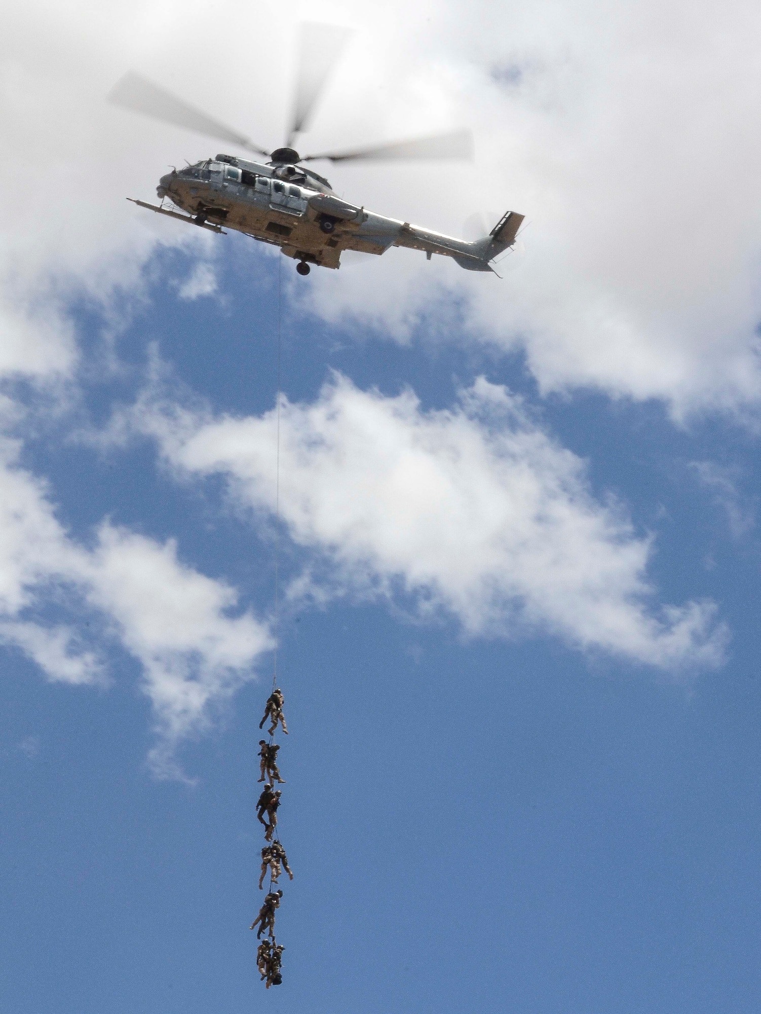 A French Eurocopter EC-735 Caracal ascends with U.S. Army, French and Swedish Special Operations Personnel, while conducting Alternate Insertion Extraction  training during Exercise ANGEL THUNDER May 07, 2014 at Davis-Monthan Air Force Base, Ariz. ANGEL THUNDER 2014 is the largest and most realistic joint service, multinational, interagency combat search and rescue exercise designed to provide training for personnel recovery assets using a variety of scenarios to simulate deployment conditions and contingencies. Personnel recovery forces will train through the full spectrum of personnel recovery capabilities with ground recovery personnel, air assets, Special Forces teams and federal agents. (U.S. Air Force photo by Staff Sgt. Adam Grant/Released)