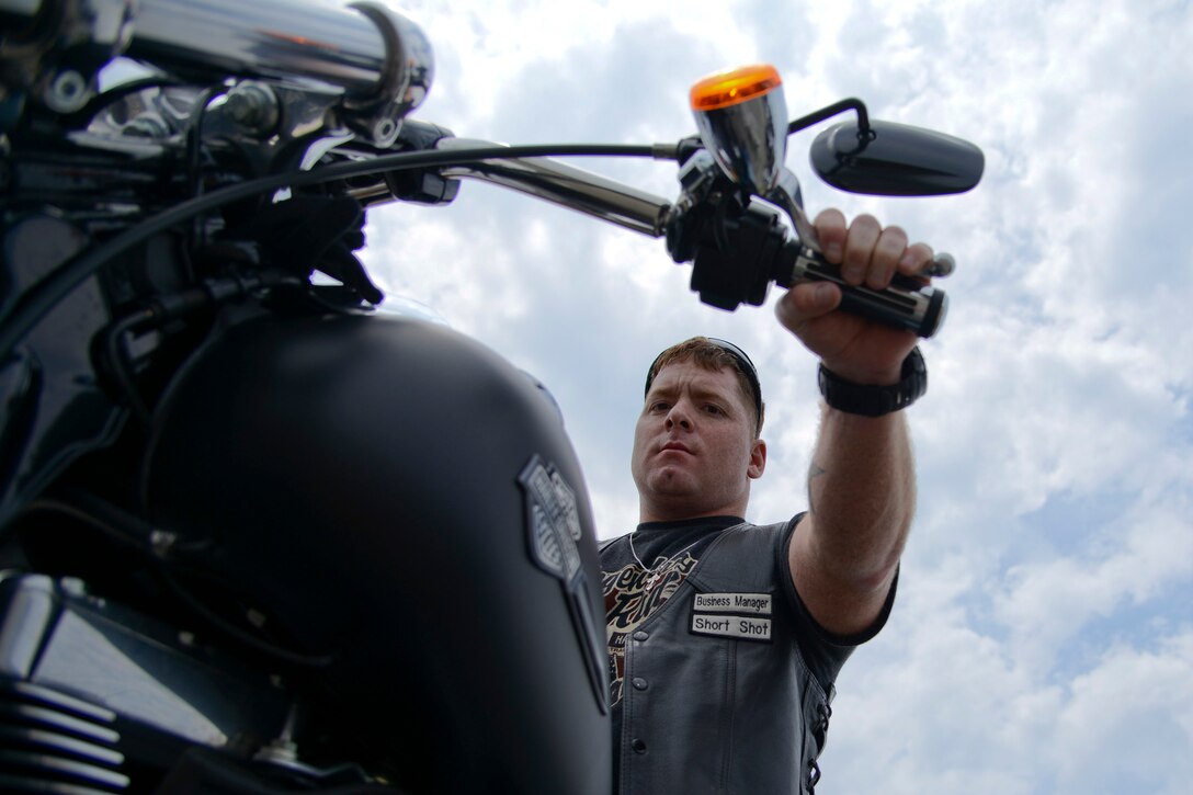 U.S. Army Staff Sgt. Robert Williams, Fort Eustis Human Resources noncommissioned officer in charge, mounts his motorcycle after participating in a more than 70-mile ride during the Standing Together Against Rape Road Rally at Langley Air Force Base, Va., May 7, 2014. Williams said the event allowed him to express his adverse feelings toward sexual assault. (U.S. Air Force photo by Airman 1st Class Devin Scott Michaels/Released)(This image was cropped to emphasize the subject; the levels were slightly adjusted for aesthetic purposes)
