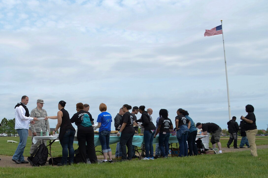 Standing Together Against Rape Road Rally volunteers hand out food to U.S. Service member motorcyclists at Langley Air Force Base, Va., May 7, 2014. U.S. Air Force Col. John J. Allen Jr. kicked off the rally with a speech about the Air ForceÕs zero-tolerance policy on sexual assault. Then, bikers rode for more than 70 miles. (U.S. Air Force photo by Airman 1st Class Devin Scott Michaels/Released)(This image was cropped to emphasize the subject; the levels were slightly adjusted for aesthetic purposes)

