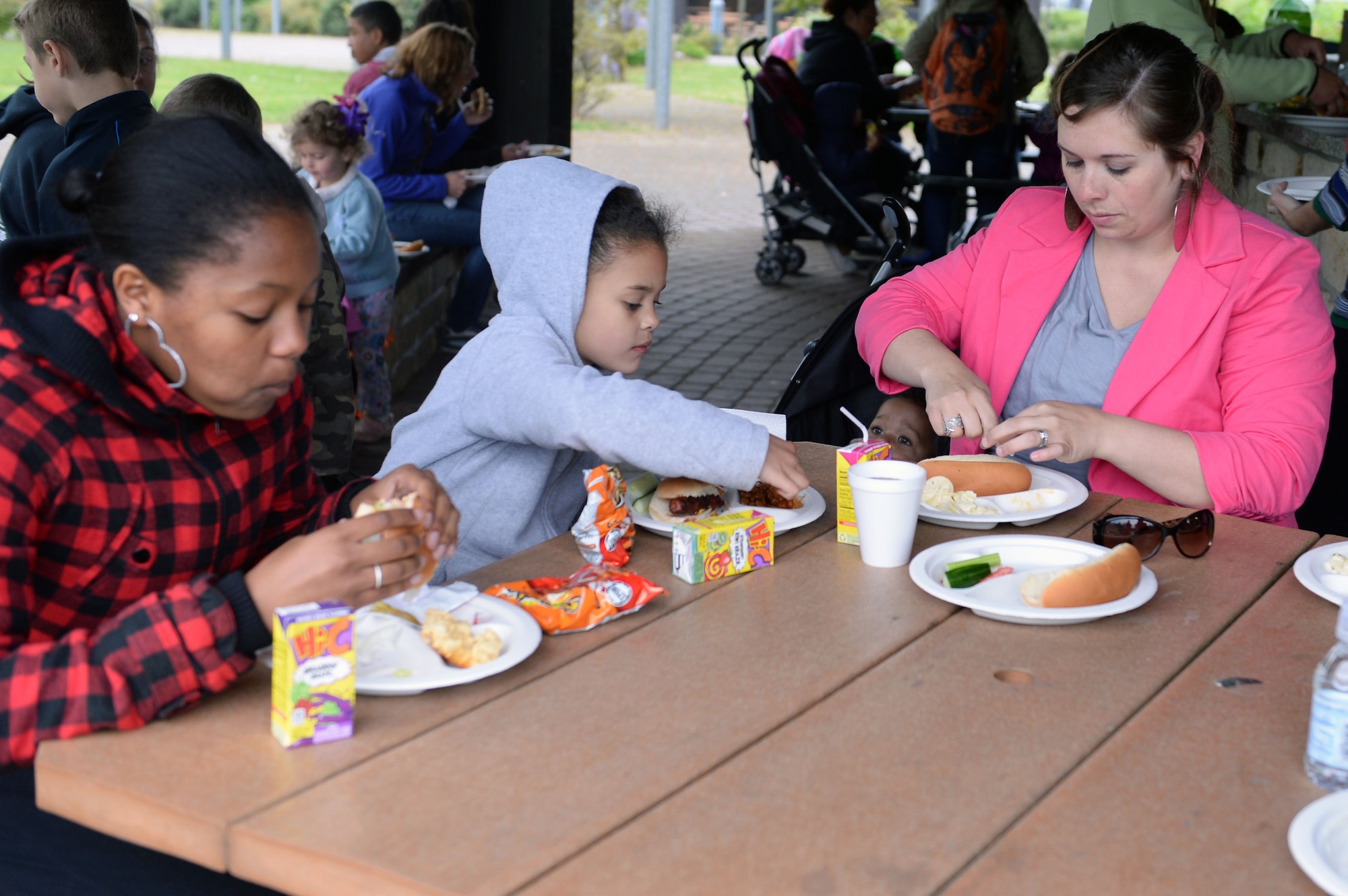 Family members of deployed 52nd Fighter Wing Airmen dig into grilled burgers, chicken, hot dogs and sides at the Airman & Family Readiness Center’s deployed family member dinner at the wing pavilion on Spangdahlem Air Base, Germany, May 8, 2014. These monthly dinners offer a chance for family members to stay connected with the base while their Airman is deployed. (U.S. Air Force photo by Senior Airman Alexis Siekert/Released)