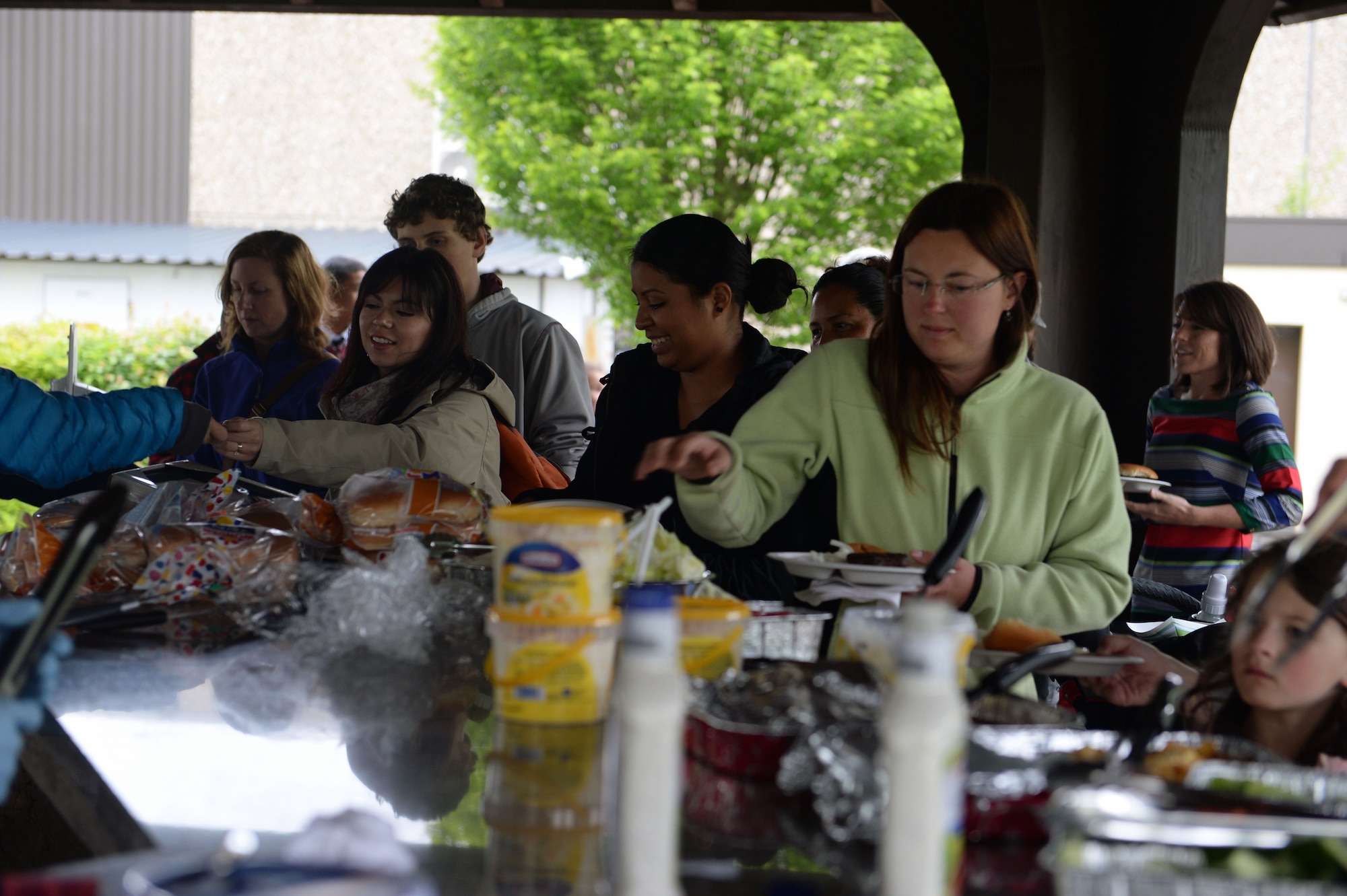 Family members of deployed 52nd Fighter Wing Airmen fill their plates at the Airman & Family Readiness Center’s deployed family member dinner at the wing pavilion on Spangdahlem Air Base, Germany, May 8, 2014. The A&FRC hosts deployed family member dinners monthly. (U.S. Air Force photo by Senior Airman Alexis Siekert/Released)
