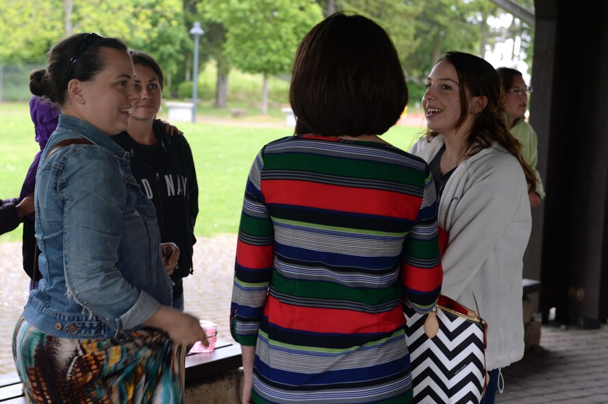 Spouses of deployed service members chat before dinner at the Airman & Family Readiness Center’s deployed family member dinner at the wing pavilion on Spangdahlem Air Base, Germany, May 8, 2014. The dinners assist in maintaining a healthy community and involvement for spouses while their spouses are deployed. (U.S. Air Force photo by Senior Airman Alexis Siekert/Released)