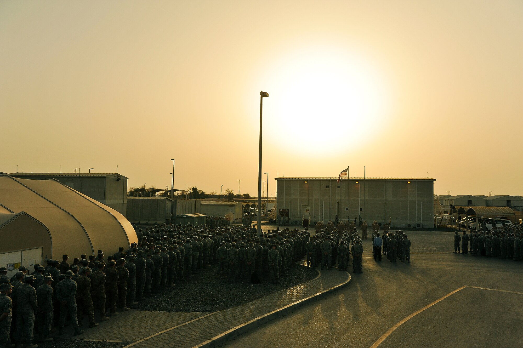 Airmen from the 380th Air Expeditionary Wing stand in formation during a Retreat Ceremony May 2, 2014, at an undisclosed location in Southwest Asia. Service members assigned to the wing gather once per month to participate in the ceremony.  (U.S. Air Force photo byTech. Sgt. Russ Scalf/Released)