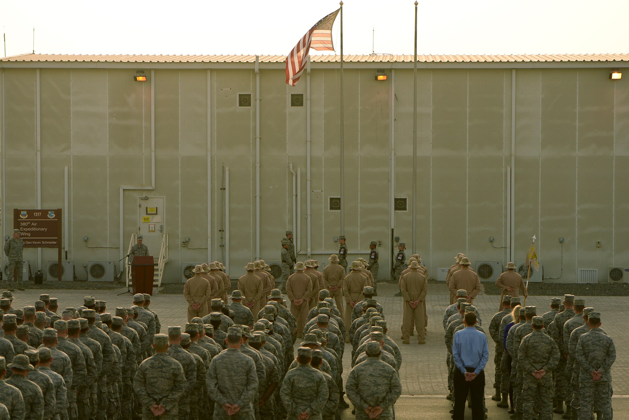 Airmen from the 380th Air Expeditionary Wing stand in formation during a Retreat Ceremony May 2, 2014, at an undisclosed location in Southwest Asia. Service members assigned to the wing gather once each month to participate in the ceremony.  (U.S. Air Force photo byTech. Sgt. Russ Scalf/Released)