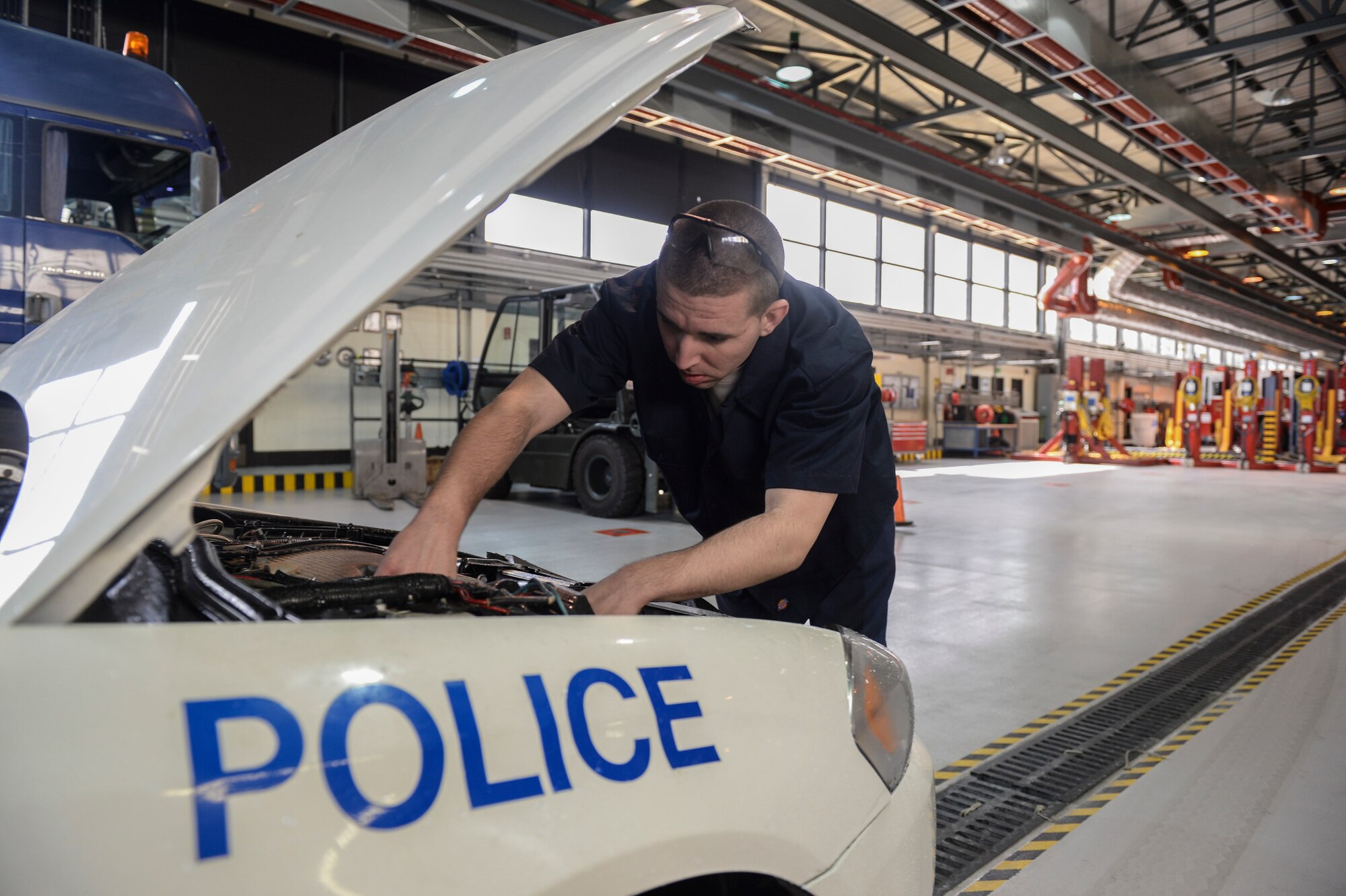 Senior Airman Shane Boling, 48th Logistics Readiness Squadron vehicle maintenance journeyman,  checks the power steering pump for leaks on a K-9 unit police car at the material handling equipment shop on Royal Air Force Lakenheath, England, May 6, 2014. Inspections are done on all repairs to ensure effectiveness and safety. (U.S. Air Force photo by Airman 1st Class Nigel Sandridge/Released)