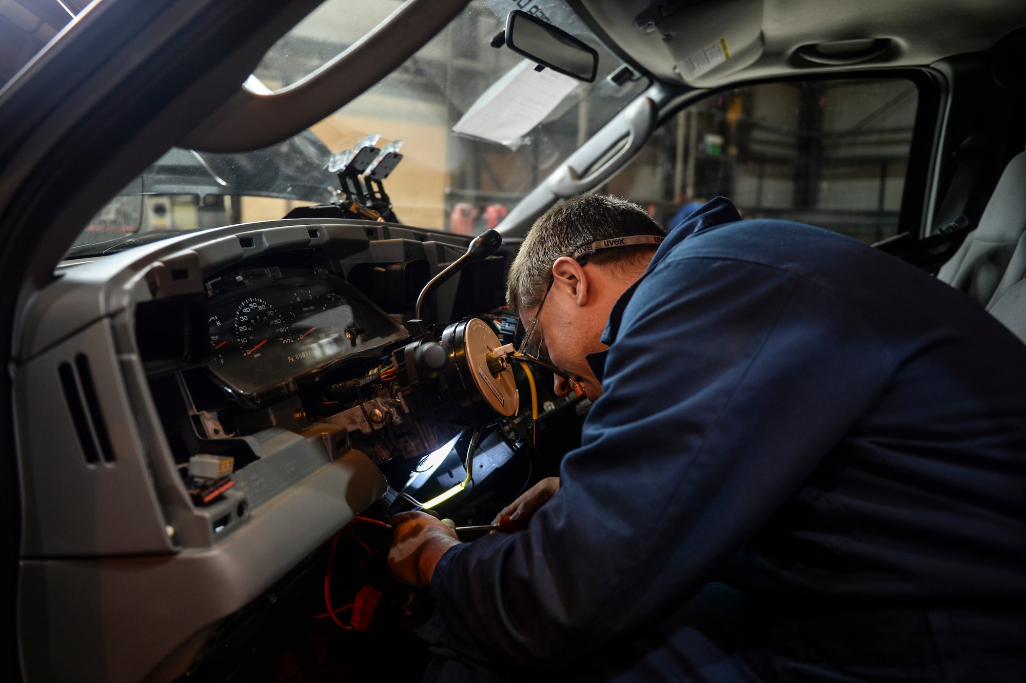 Mark Hayes, 48th Logistics Readiness Squadron skill zone three mechanic, replaces the clock spring on a steering wheel at the major maintenance shop on Royal Air Force Lakenheath, England, May 6, 2014. The clock spring sends power to the wheel’s horn and air bag features. (U.S. Air Force photo by Airman 1st Class Nigel Sandridge/Released)