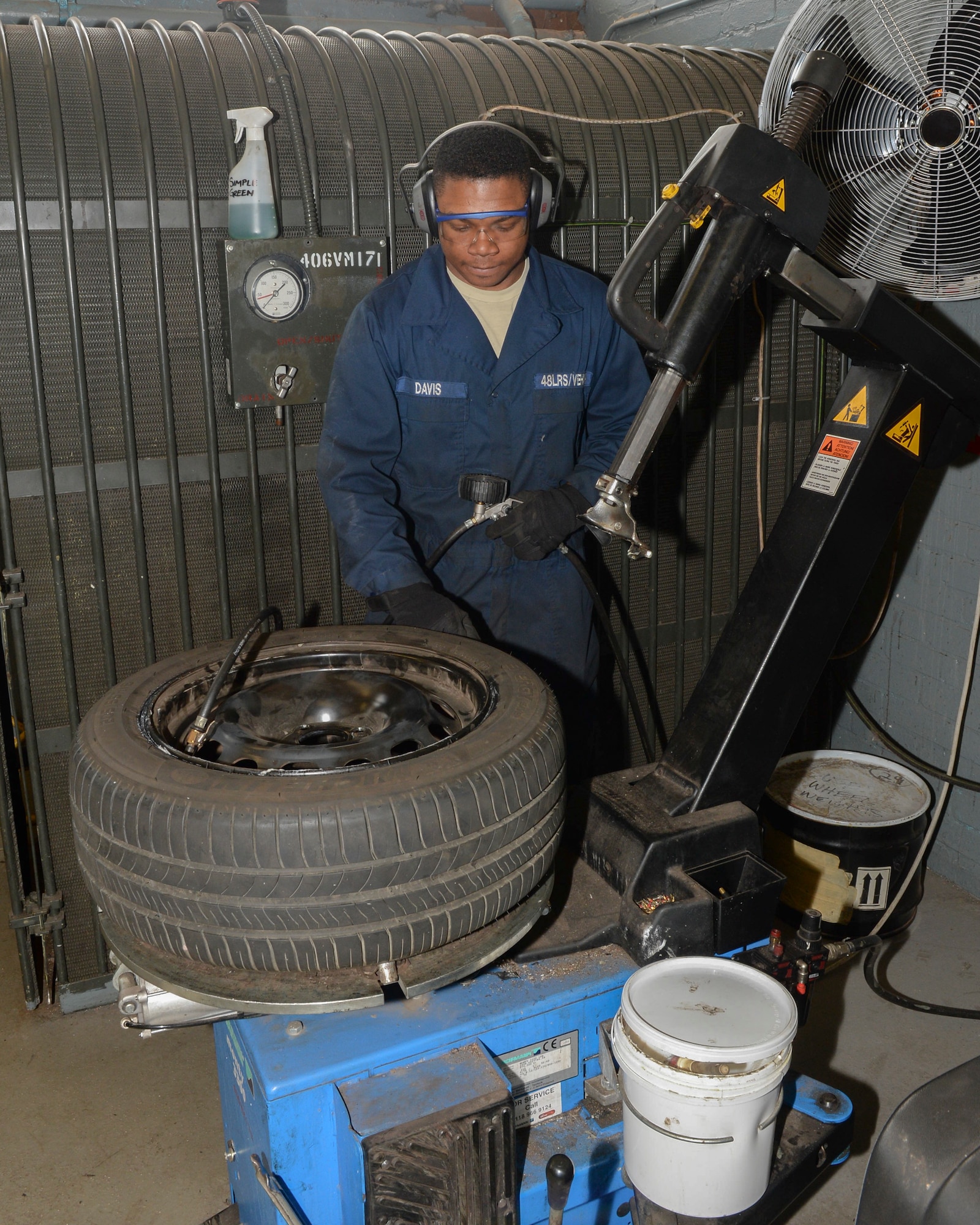 Airman 1st Class Robert Davis, 48th Logistics Readiness Squadron vehicle maintenance apprentice, fills a tire with air to 15 psi at the minor maintenance shop on Royal Air Force Lakenheath, England, May 6, 2014. The proper amount of pressure is needed to help a tire sit successfully in a rim without causing damage. (U.S. Air Force photo by Airman 1st Class Nigel Sandridge/Released)