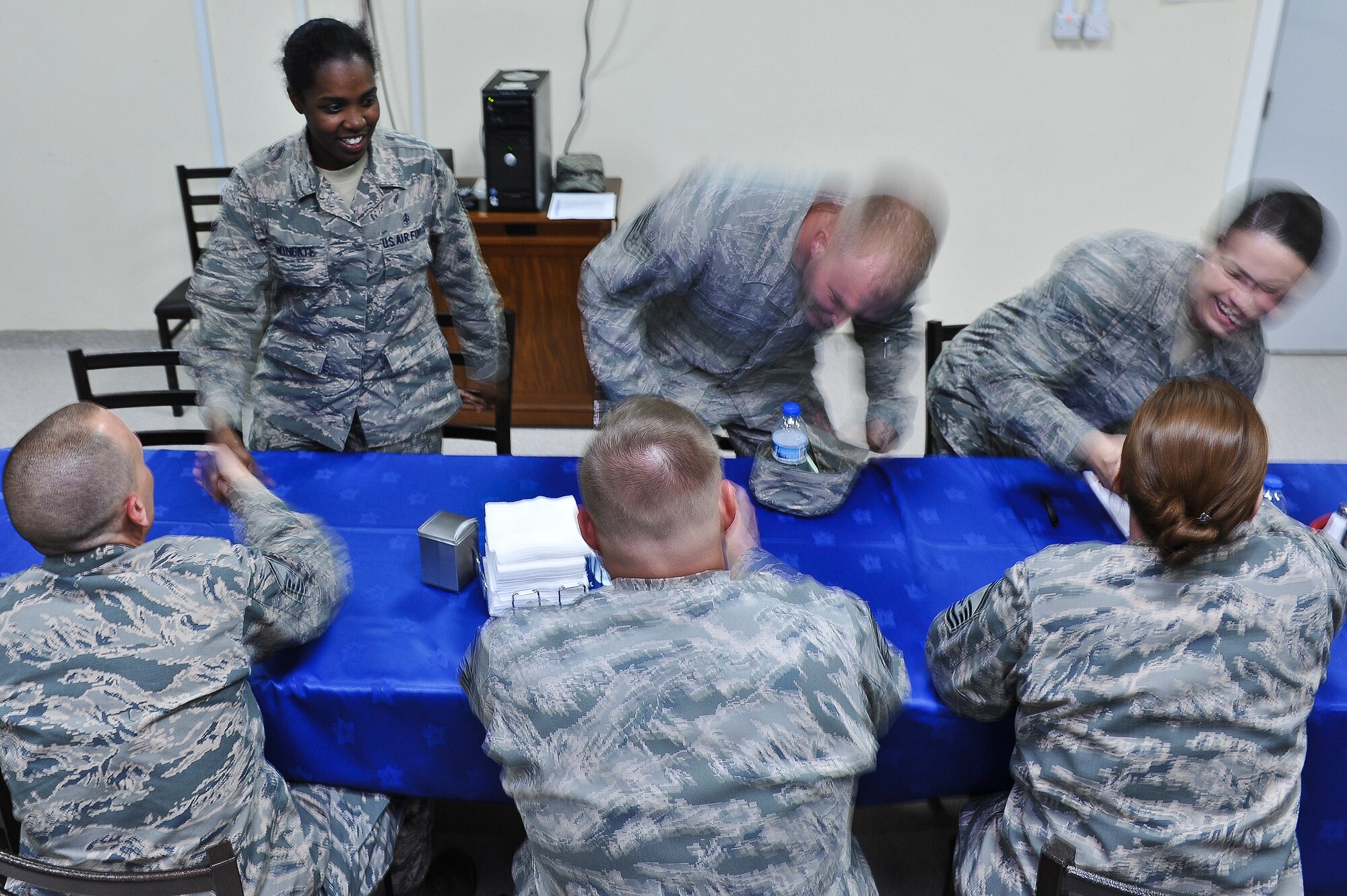 Airmen from the 380th Air Expeditionary Wing switch mentors during a speed mentorship event May 6, 2014, at an undisclosed location in Southwest Asia. In all, 46 participants showed up to give and receive advice.  (U.S. Air Force photo byTech. Sgt. Russ Scalf/Released)