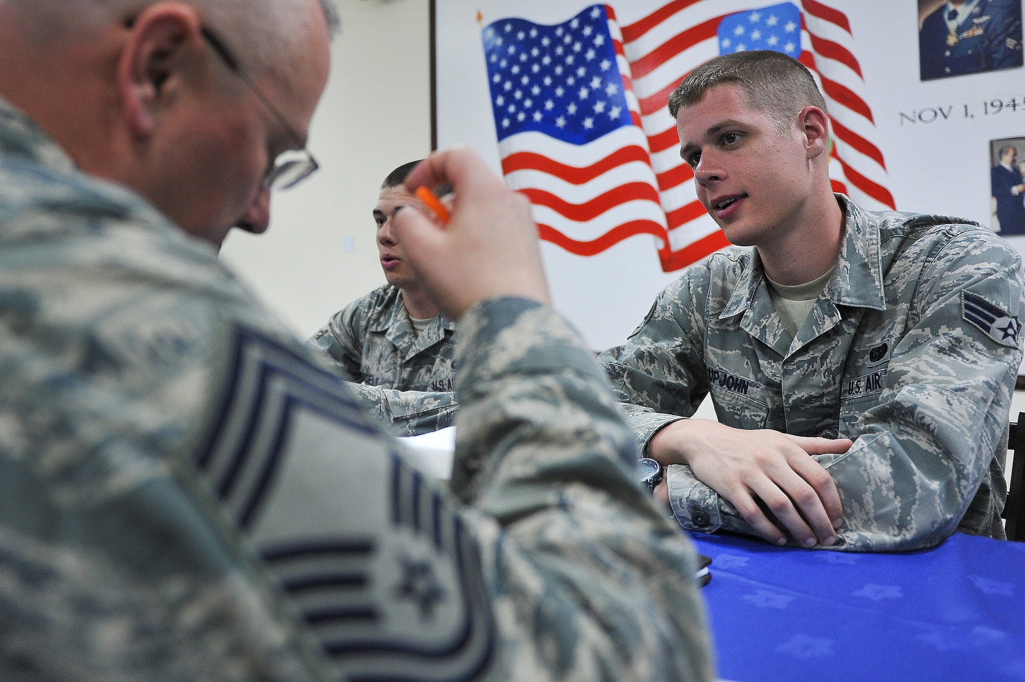 Senior Airman Upjohn, 380th Expeditionary Communications Squadron, speaks with Chief Master Sgt. Jeff Rud, 380th Expeditionary Maintenance Squadron, during a speed mentoring event May 6, 2014, at an undisclosed location in Southwest Asia. The event was hosted by the 380th Air Expeditionary Wing Top 3 organization. (U.S. Air Force photo byTech. Sgt. Russ Scalf/Released)