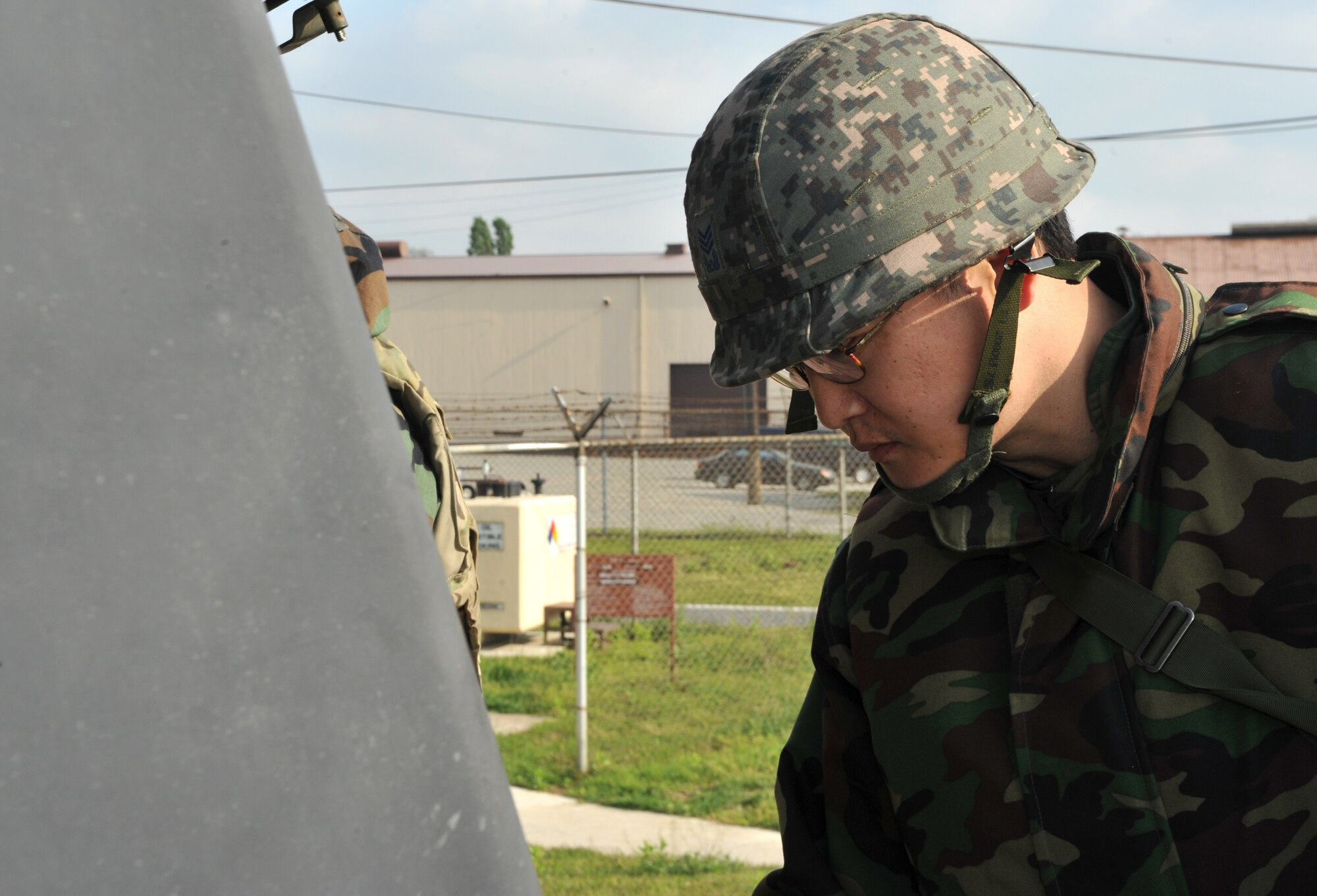 A member of the Republic of Korea air force prepares for an unexploded ordnance scenario during Operational Readiness Exercise Beverly Bulldog 14-02 at Osan Air Base, Republic of Korea, May 8, 2014. Airmen who discover a UXO are instructed to confirm its presence, clear and cordon the area, check for additional UXOs and keep the area controlled until help arrives. (U.S. Air Force photo/Airman 1st Class Ashley J. Thum)