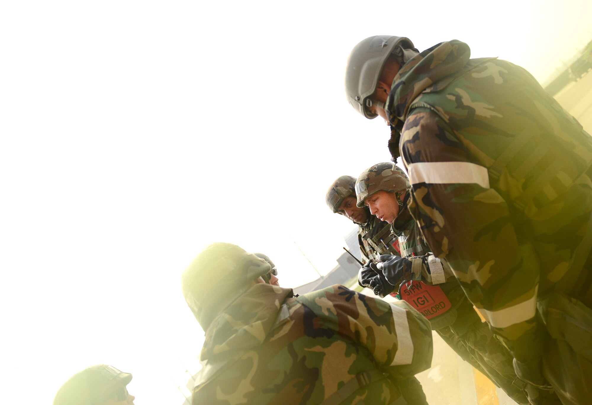 Maj. Michael Moss, 51st Fighter Wing Inspector General Office chief inspector, briefs maintainers on the flight line on proper contamination control procedures during Operational Readiness Exercise Beverly Bulldog 14-02 at Osan Air Base, Republic of Korea, May 9, 2014. The IG team is responsible for planning the wartime scenarios that the base practices and ensuring wing inspection team members are providing appropiate evaluations of their indiviual units.  (U.S. Air Force photo/Tech. Sgt. Micky M. Pena)
