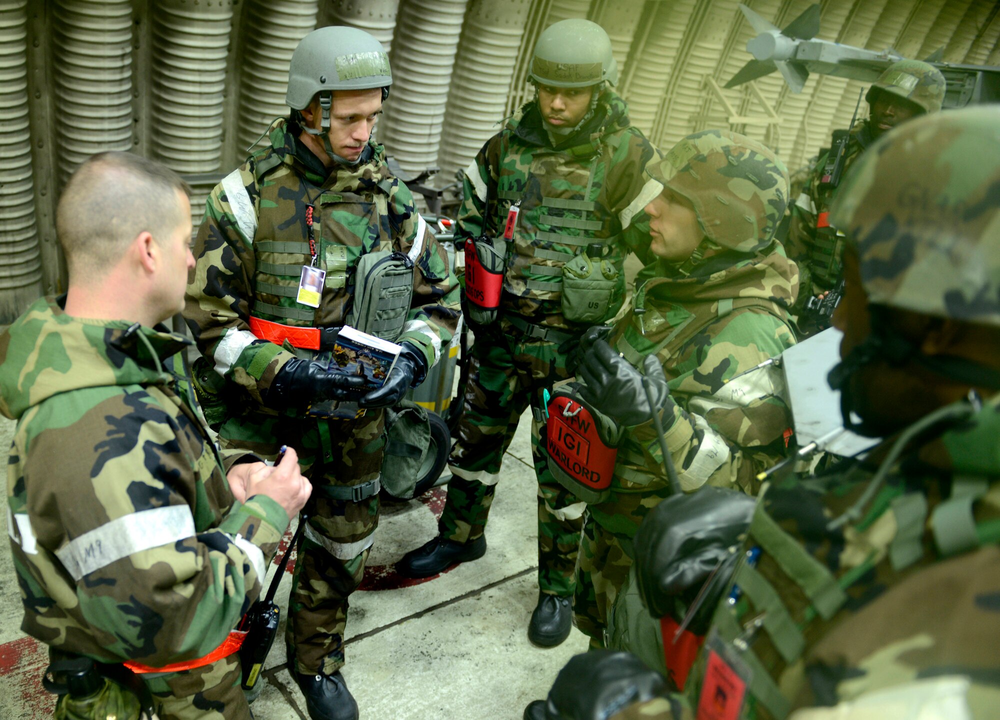 Maj. Michael Moss, 51st Fighter Wing Inspector General Office chief inspector, briefs maintainers on the flight line on proper contamination control procedures during Operational Readiness Exercise Beverly Bulldog 14-02 at Osan Air Base, Republic of Korea, May 9, 2014. The IG team is responsible for planning the wartime scenarios that the base practices and ensuring wing inspection team members are giving appropiate evaluations of their indiviual units. (U.S. Air Force photo/Tech. Sgt. Micky M. Pena)