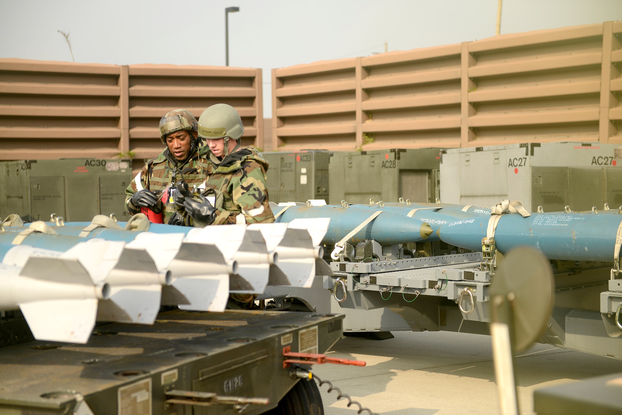 Master Sgt. Wendell Runnels (left), 51st Fighter Wing Inspector General Office deputy inspector, examines vehicles on the flight line to ensure they are properly marked with M-8 chemical detection paper during Operational Readiness Exercise Beverly Bulldog 14-02 at Osan Air Base, Republic of Korea, May 9, 2014. M-8 paper detects nerve and blister agents and is used during exercises and real world contingencies for contamination control procedures. (U.S. Air Force photo/Tech. Sgt. Micky M. Pena)
