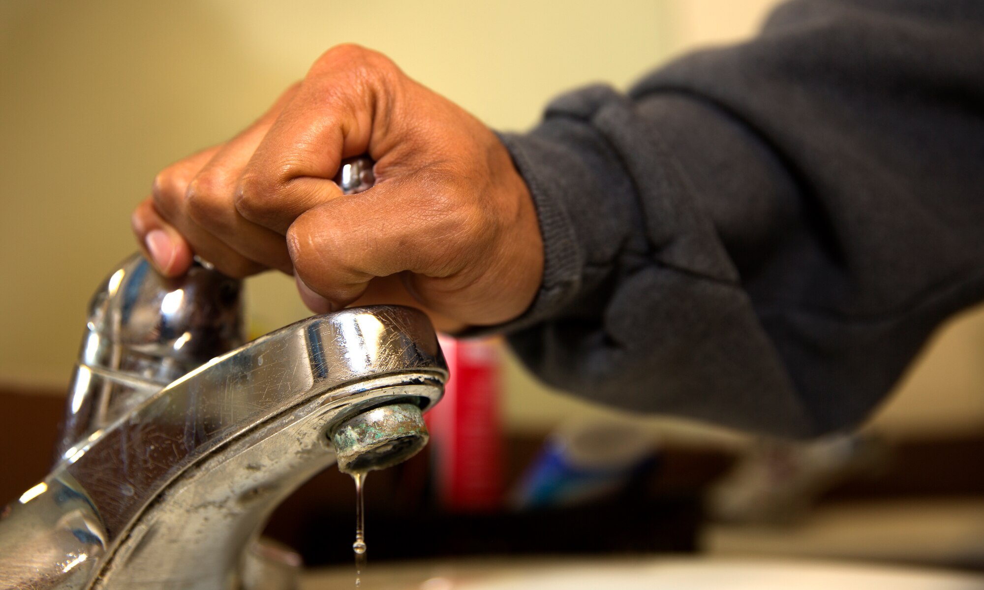 A Marine turns off the faucet while preparing for work aboard Marine Corps Air Station Miramar, Calif., May 9. Marines, Sailors, families and civilians working and living aboard the air station take part in fighting the drought in California by cutting their water usage wherever they can.