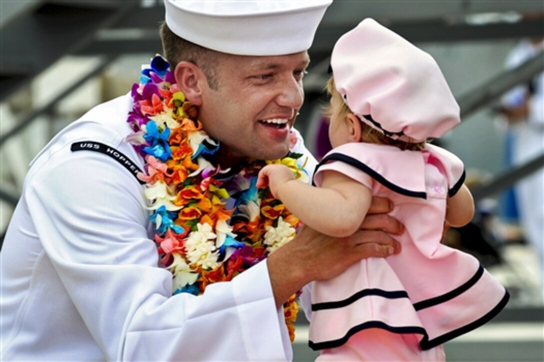 U.S. Navy Petty Officer 2nd Class Jeremiah Miller, assigned to the guided-missile destroyer USS Hopper, greets his daughter upon the ship's return to homeport on Joint Base Pearl Harbor-HIckam, Hawaii, May 6, 2014, from an independent deployment to the U.S. 5th and 7th Fleet areas of responsibility. Miller is a interior communications electrician. 