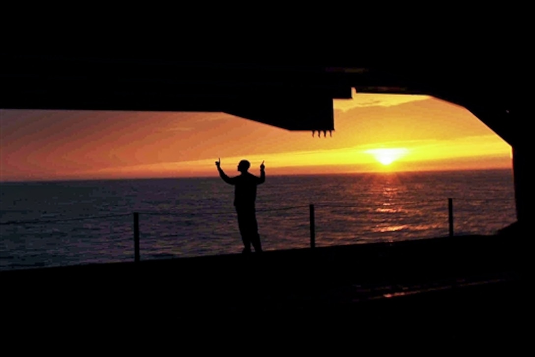 A Navy sailor directs the raising of an aircraft elevator to the flight deck aboard the aircraft carrier USS Theodore Roosevelt in the Atlantic Ocean, May 2, 2014. The Theodore Roosevelt is underway conducting training exercises in preparation for future deployments. 