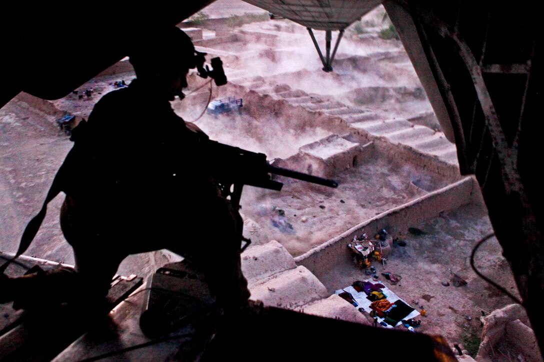 U.S. Marine Sgt. Eric R. Wagner provides aerial security from the back of a CH-53E Super Stallion helicopter during an operation over Helmand province in Afghanistan, July 18, 2013. Wagner, a crew chief, is assigned to Marine Heavy Helicopter Squadron 461. 
