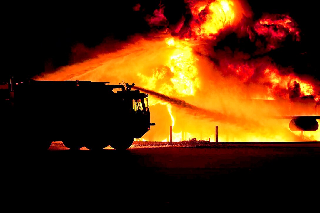 U.S. Air Force firefighters extinguish a simulated aircraft fire as part of an operational readiness exercise on Ellsworth Air Force Base, S.D., July 15, 2013. The firefighters, assigned to the 28th Civil Engineer Squadron Fire Department, use exercises to hone their skills for real-world operations.  
