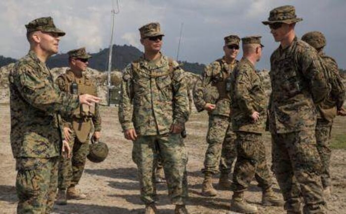 U.S. Marine Corps Col. Mark M. Walter, left, deputy commander, U.S. Marine Forces Balikatan 2014, discusses the setup of the ammunition supply point with U.S. Marine Corps Cpl. David S. Wright, right, the noncommissioned officer in charge for the ammunition supply point, May 3, 2014 in Crow Valley, Philippines. Walter visited the base camp where Balikatan 2014 will hold part of its field training exercise with the Armed Forces of the Philippines. Balikatan is an annual training exercise that strengthens the interoperability between the Armed Forces of the Philippines and U.S. military in their commitment to regional security and stability, humanitarian assistance and disaster relief. Wright is assigned to 3rd Maintenance Battalion, Combat Logistics Regiment 35, 3rd Marine Logistics Group, III Marine Expeditionary Force. (U.S. Marine Corps photo by Lance Cpl. Joey S. Holeman, Jr./Released)
