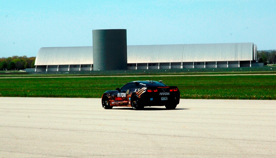 Sam Schmidt drives a 2014 Corvette C7 Stingray car down the runway next to the National Museum of the United States Air Force. Schmidt, a quadriplegic, demonstrated his ability to control the car. (USAF photo by Al Bright)