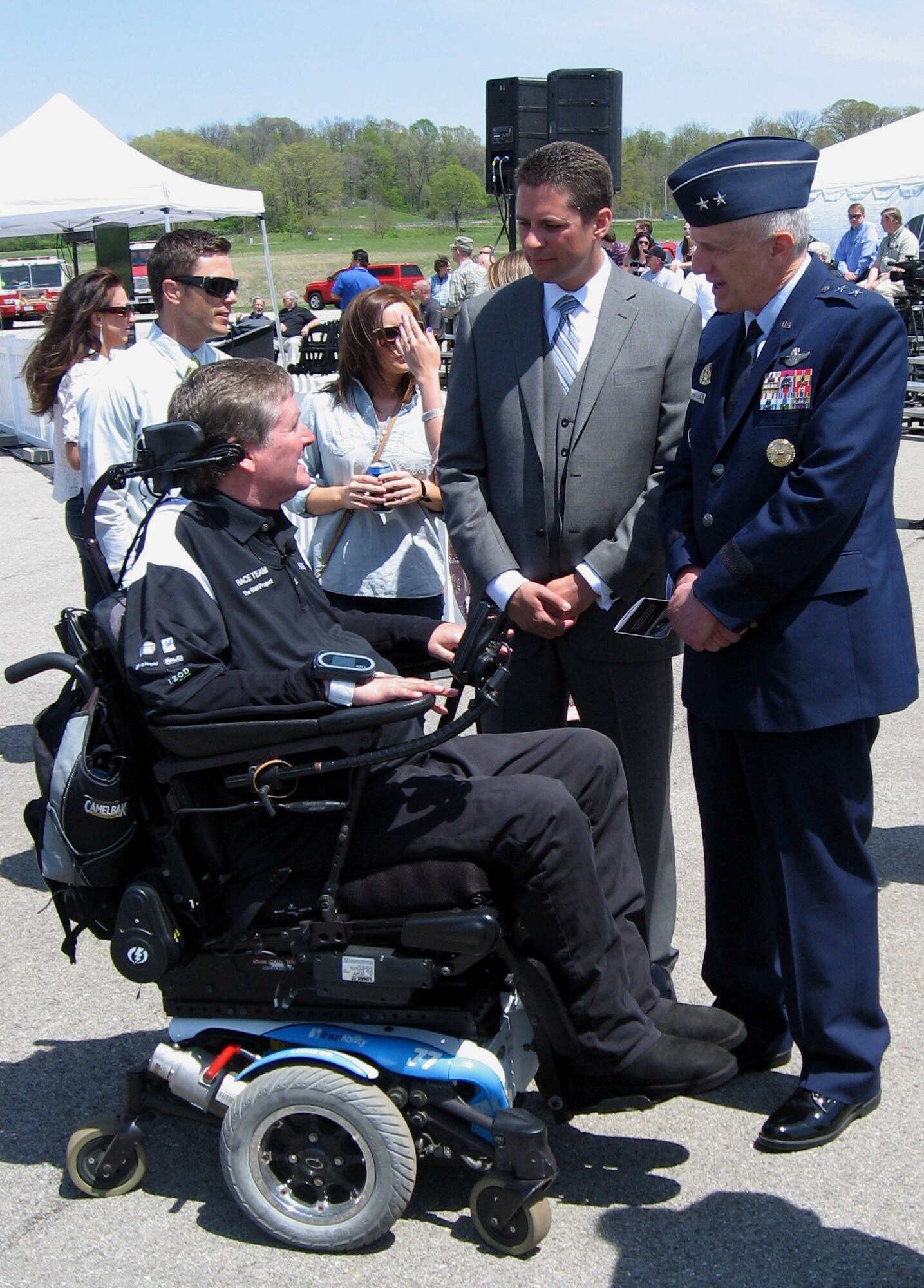 Maj. Gen. Thomas Masiello, commander of Air Force Research Laboratory and James Christensen, research psychologist with 711 Human Performance Wing talk to Sam Schmidt, a quadriplegic and former Indy Racing League driver, about driving again. (USAF photo by Ted Theopolos)
